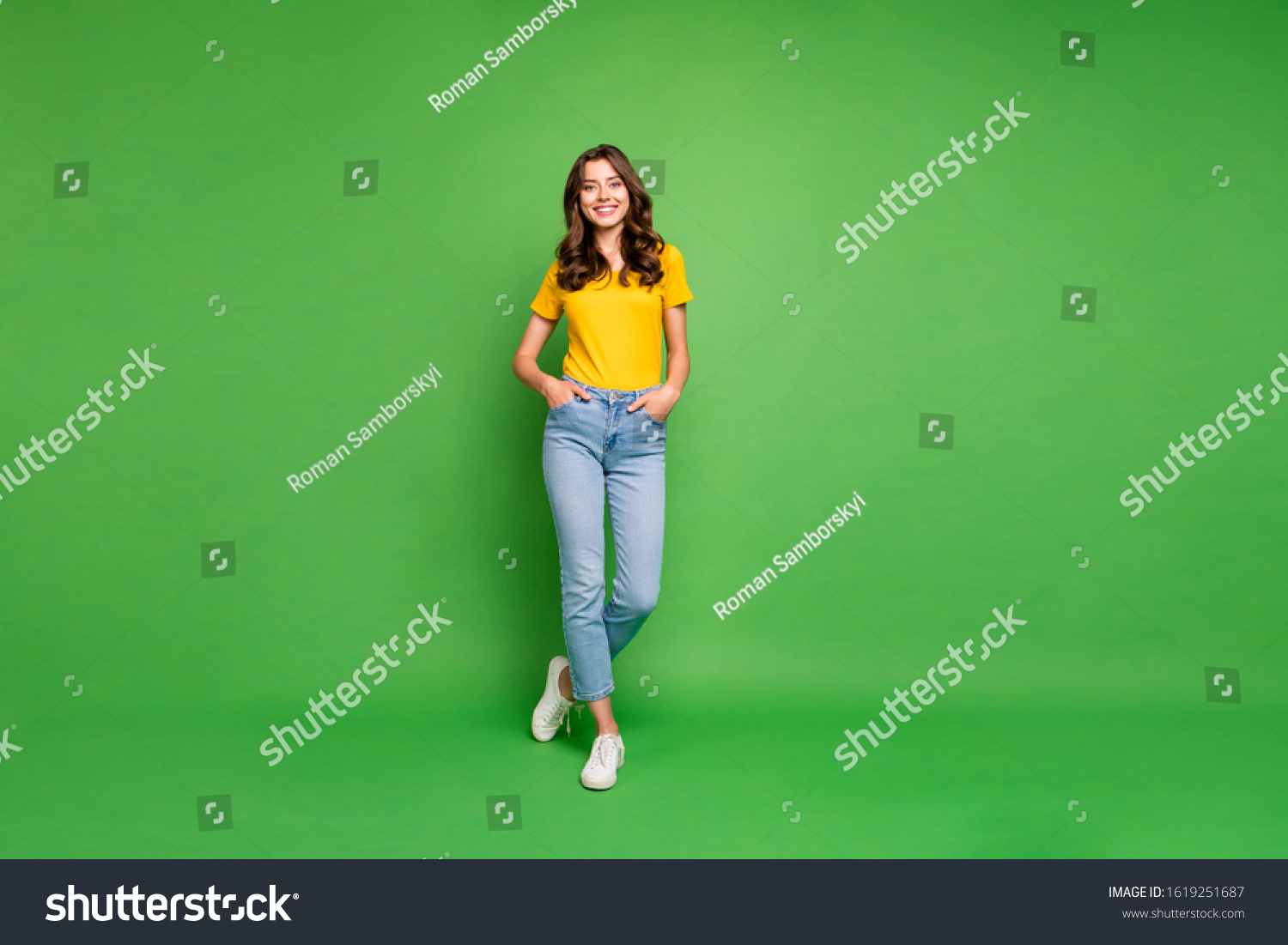 Full length body size view of her she nice attractive lovely cheerful cheery content wavy-haired girl holding hands in pockets isolated over bright vivid shine vibrant green color background #1619251687