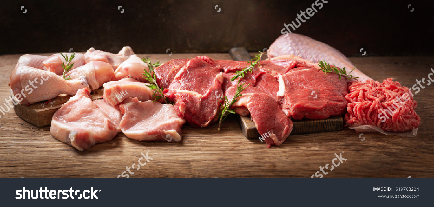 various types of fresh meat: pork, beef, turkey and chicken on a wooden table #1619708224