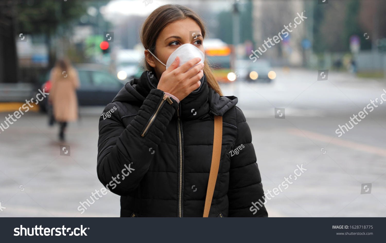 COVID-19 Pandemic Coronavirus Woman in city street wearing protective face mask for spreading of disease virus SARS-CoV-2. Girl with protective mask on face against Coronavirus Disease 2019. #1628718775