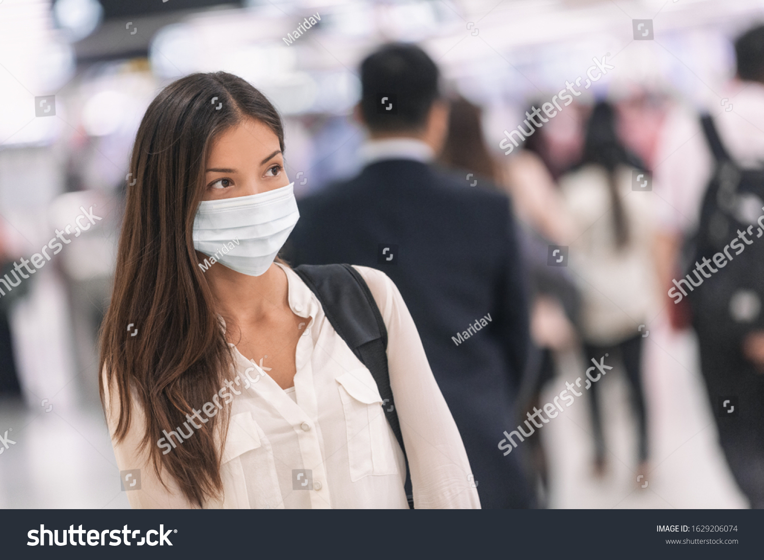 Virus mask Asian woman travel wearing face protection in prevention for coronavirus in China. Lady walking in public space bus station or airport. #1629206074