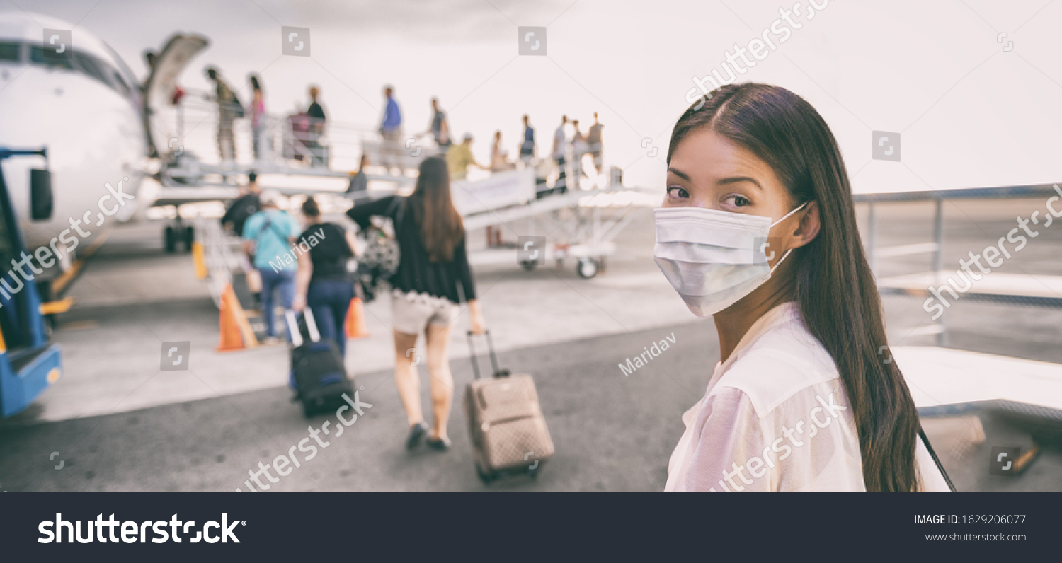COVID-19 Travel Airport Asian woman tourist boarding plane for holiday wearing face mask. PPE Corona virus Coronavirus negative test and vaccine passport banner panoramic. #1629206077