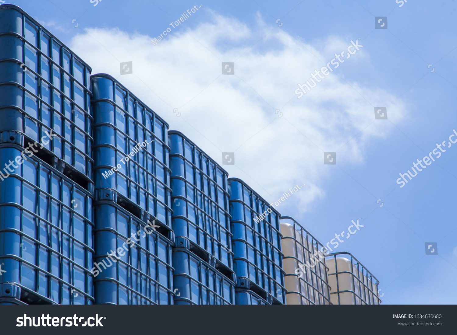 Huge industrial IBC outdoor storage with blue sky above. #1634630680