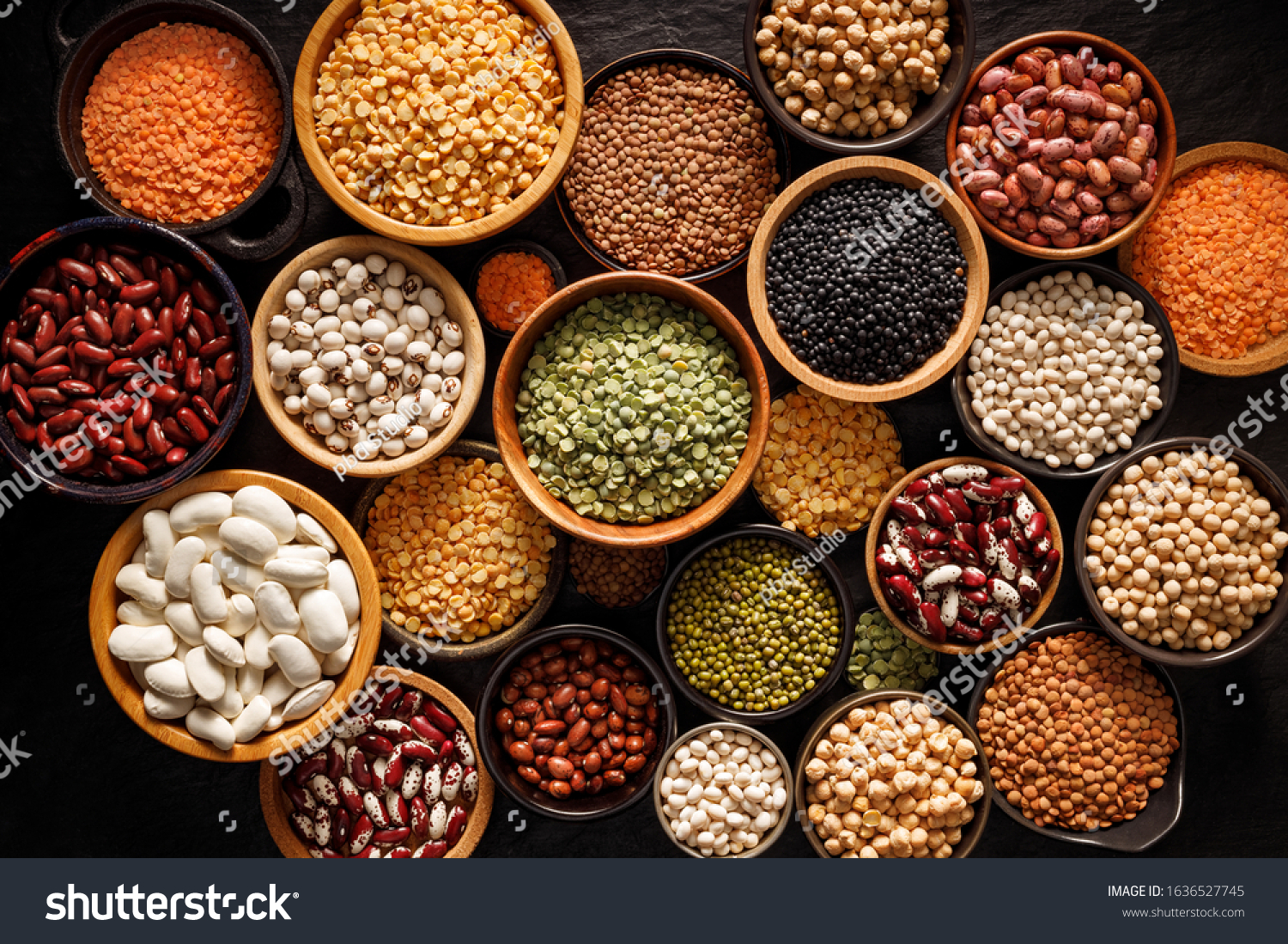 Legumes, a set consisting of different types of beans, lentils and peas on a black background, top view. The concept of healthy and nutritious food #1636527745