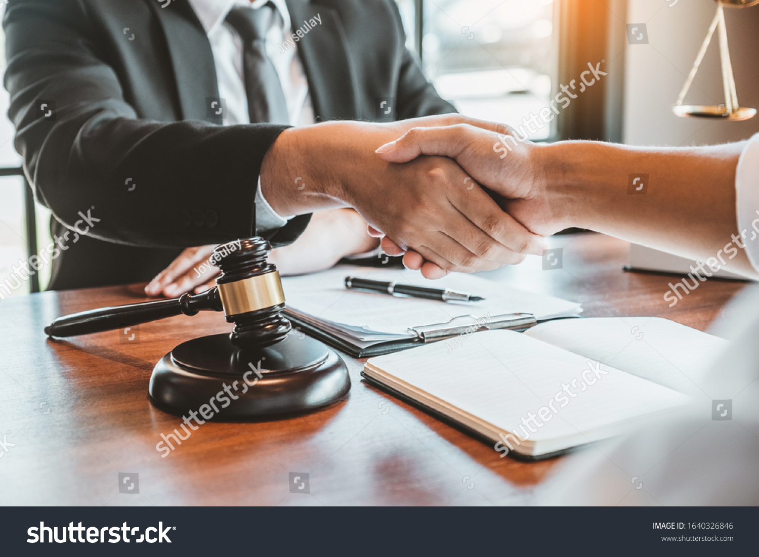 Businessman shaking hands to seal a deal Judges male lawyers Consultation legal services Consulting in regard to the various contracts to plan the case in court. #1640326846