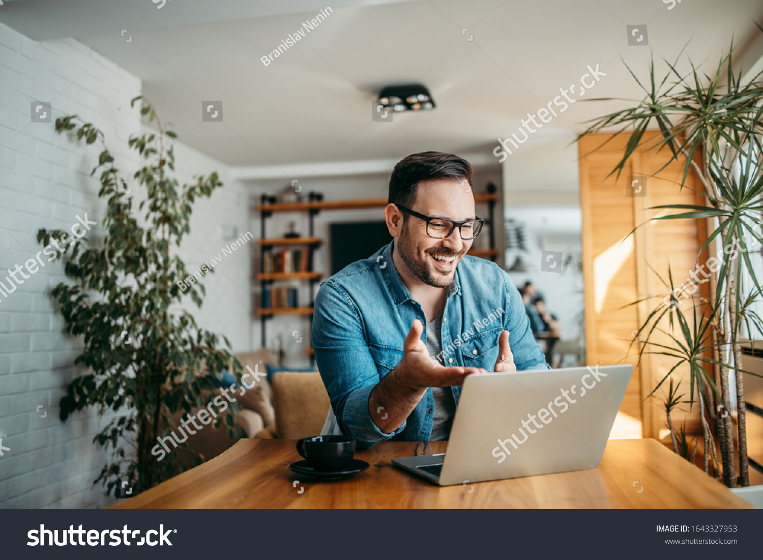 Portrait of a cheerful man having video call on laptop computer. #1643327953