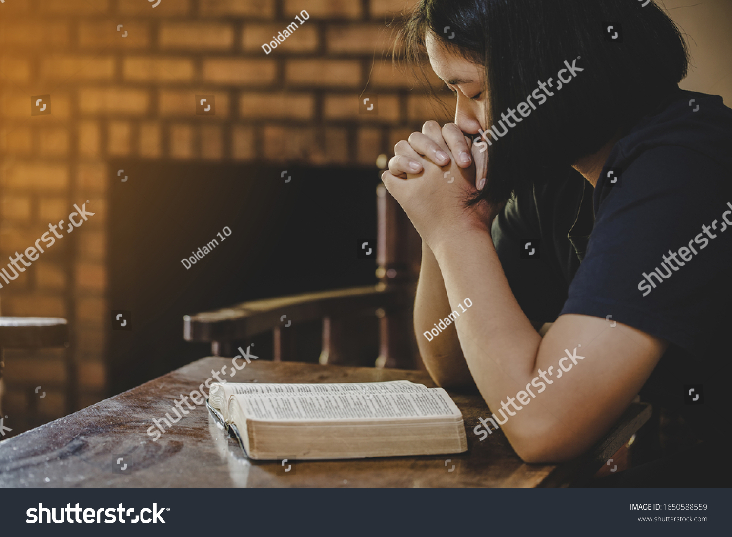 Girl while praying for christian religion, Casual woman praying with her hands  #1650588559