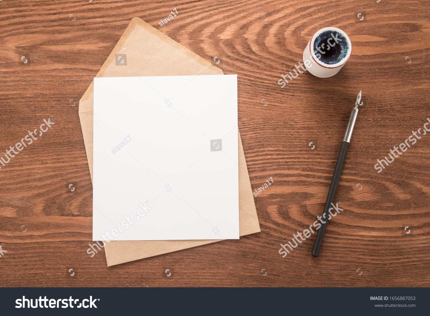 Envelope, ink pen, inkwell on a table	 #1656887053