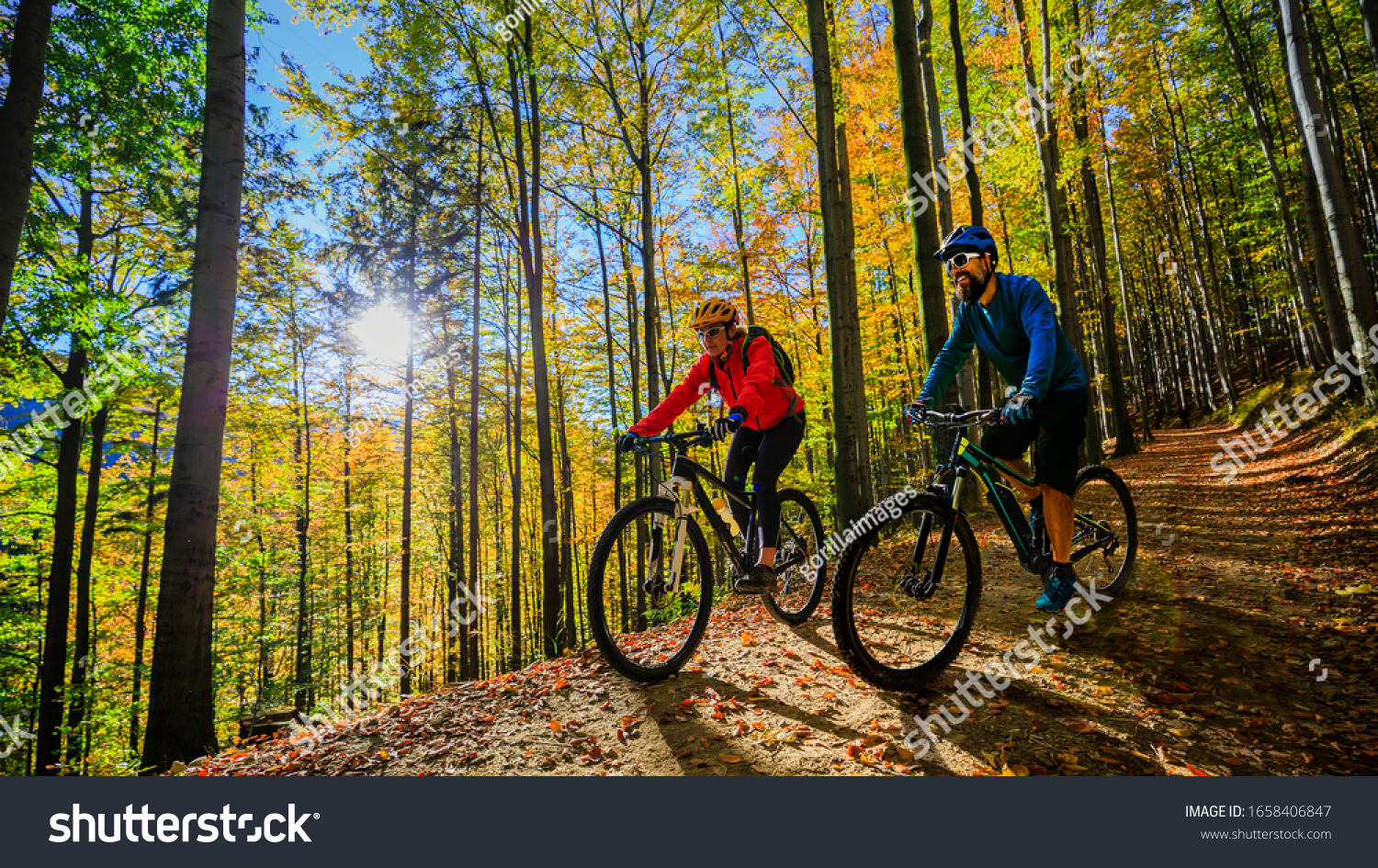 Cycling woman and man riding on bikes at sunset mountains forest landscape. Couple cycling MTB enduro flow trail track. Outdoor sport activity. #1658406847