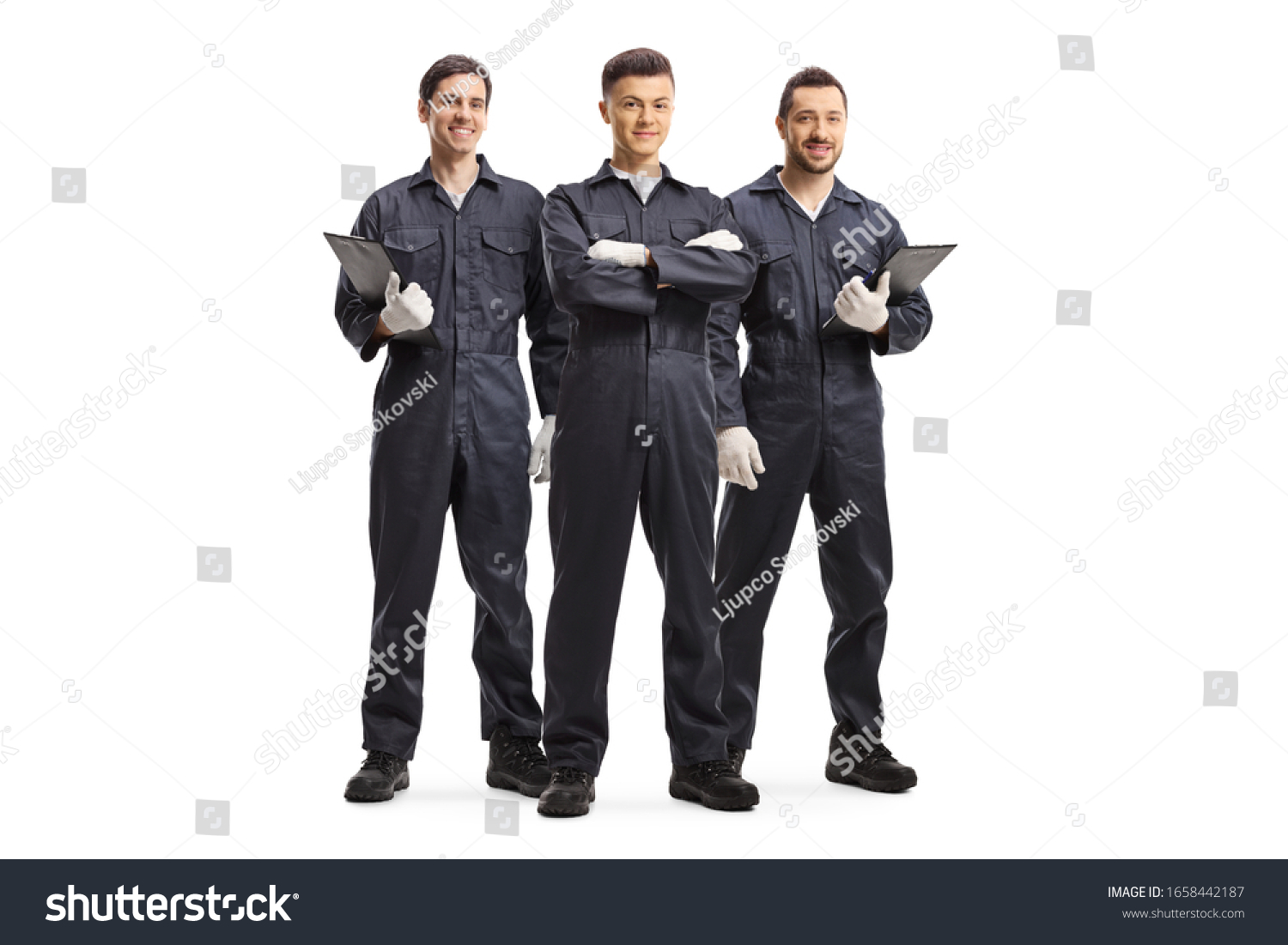 Full length portrait of three mechanic workers in uniforms isolated on white background #1658442187