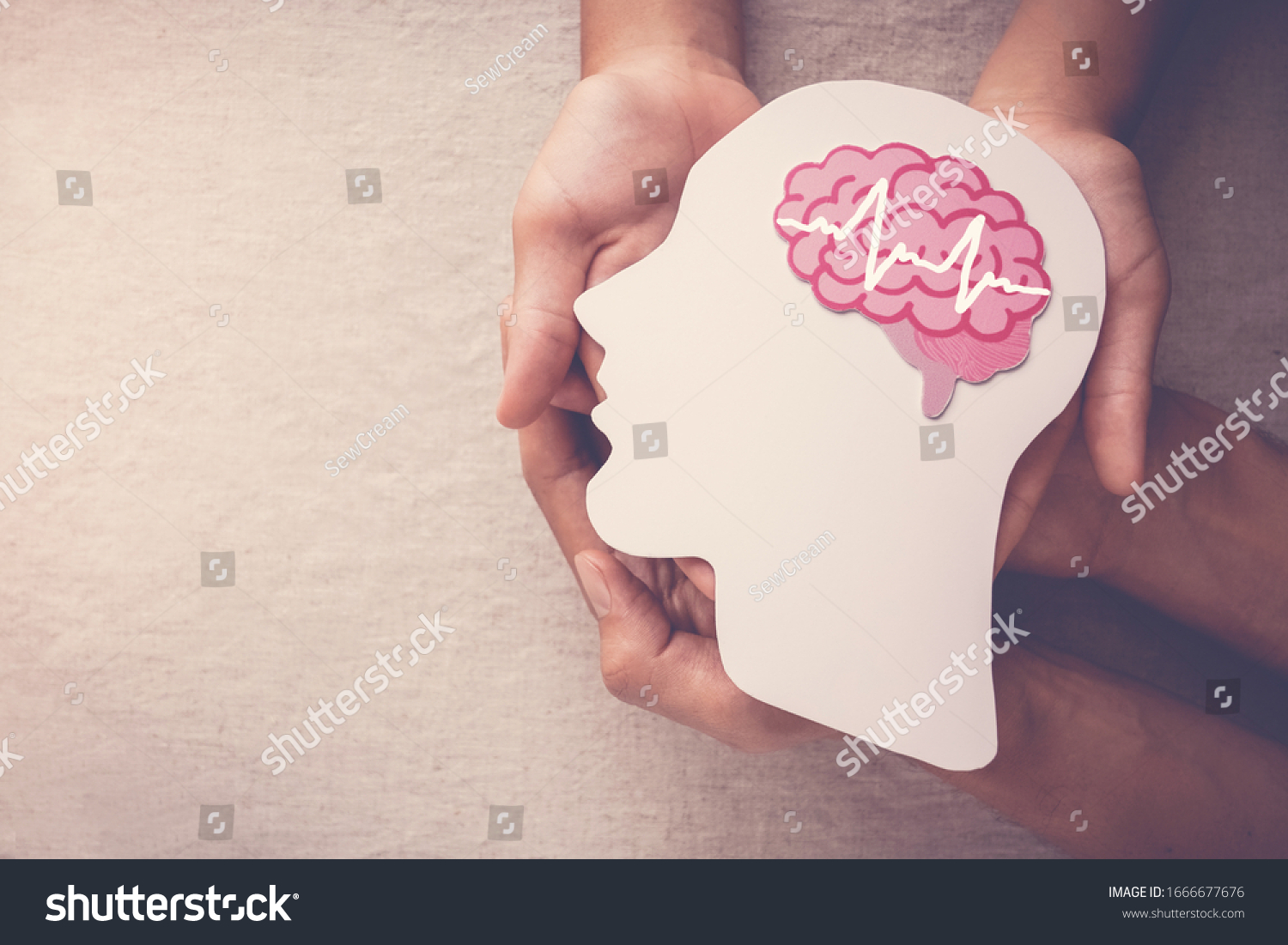 Adult and child hands holding encephalography brain paper cutout,autism, Stroke, Epilepsy and alzheimer awareness, seizure disorder, stroke, ADHD, world mental health day concept #1666677676