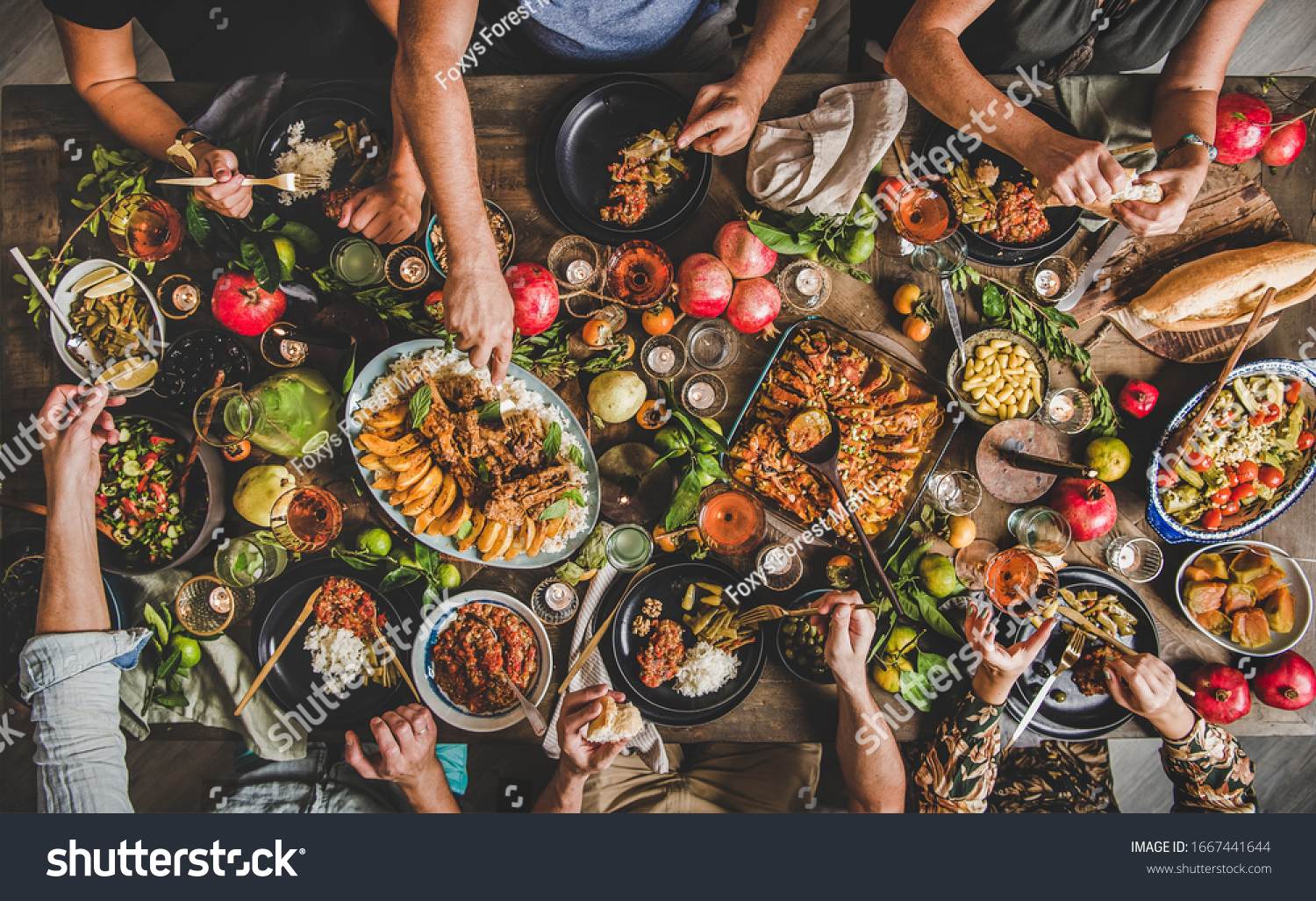 Flat-lay of family feasting with Turkish cuisine lamb chops, quince, bean, vegetable salad, babaganush, rice pilav, pumpkin dessert, lemonade over rustic table, top view. Middle East cuisine #1667441644