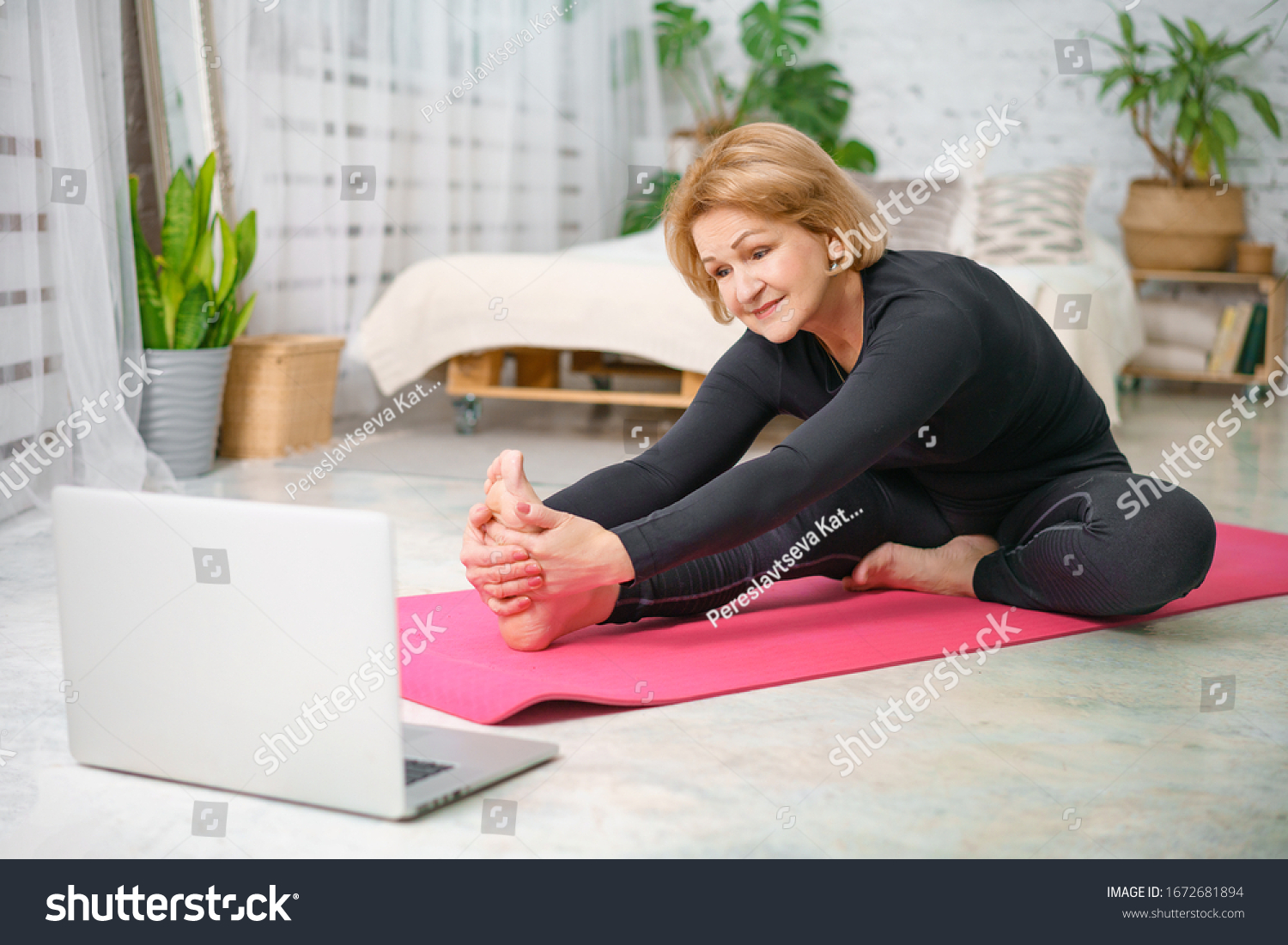 Fitness training online, senior woman at home with laptop. #1672681894