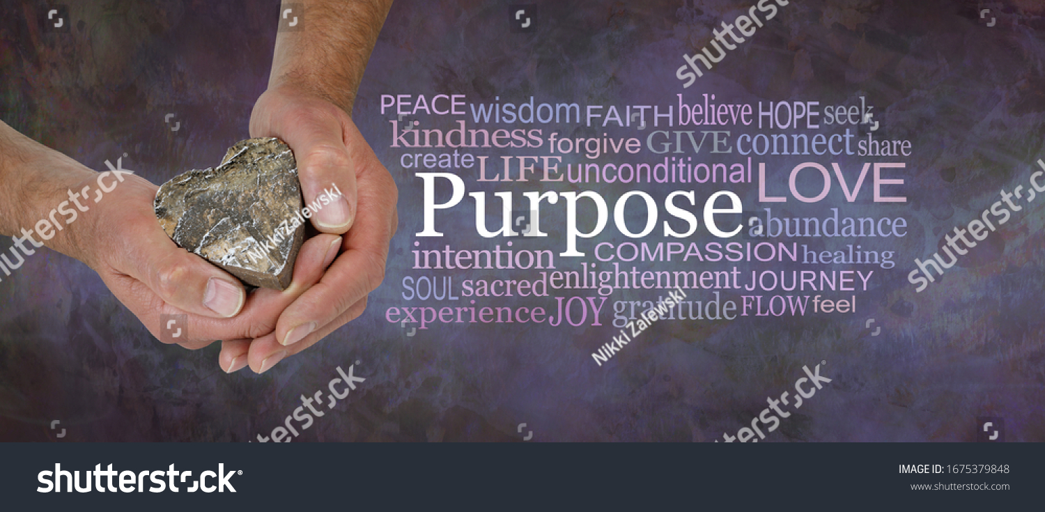 Love is our True Soul Purpose - male hands holding a wooden love heart beside a PURPOSE word cloud against a rustic dark purple brown stone grunge background
                                #1675379848