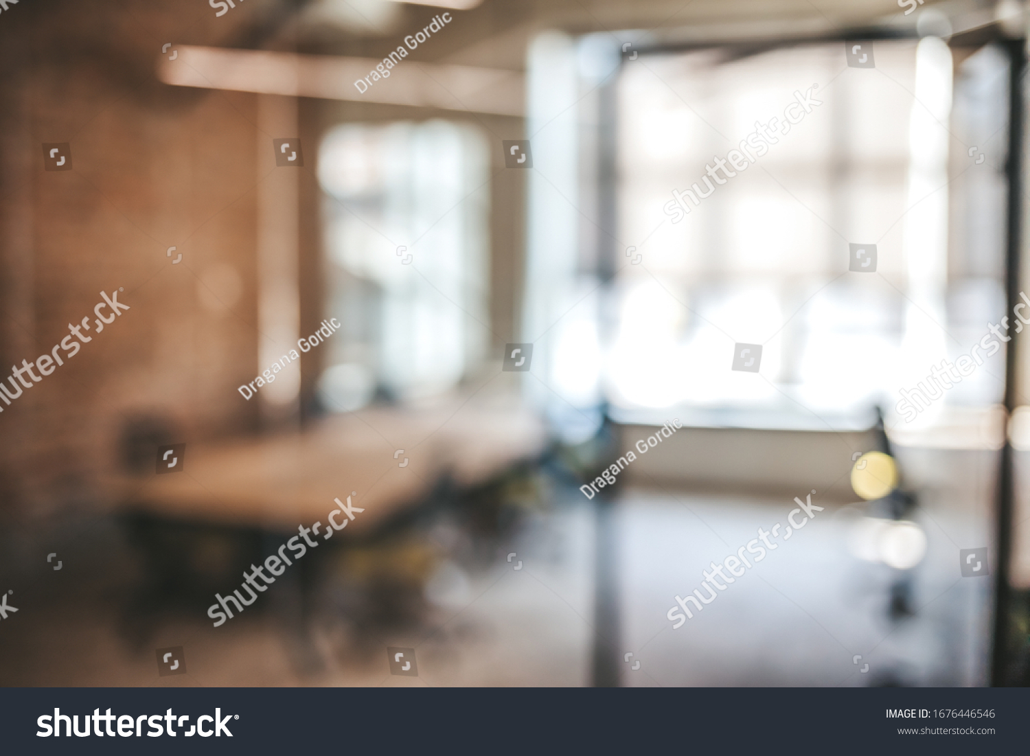 Blurred office interior space background. Blurred interior of modern office workplace a workspace design without partition decorate with black, white and wooden furniture #1676446546