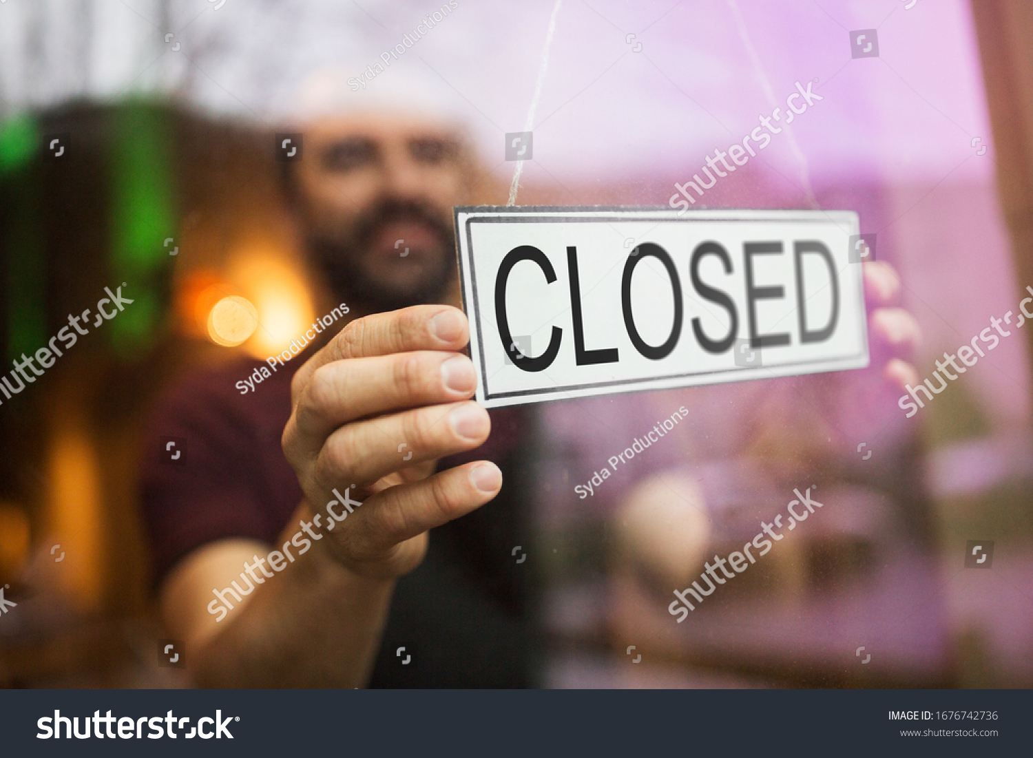small business, people and crisis concept - owner puts closed sign at bar or restaurant glass door or window #1676742736