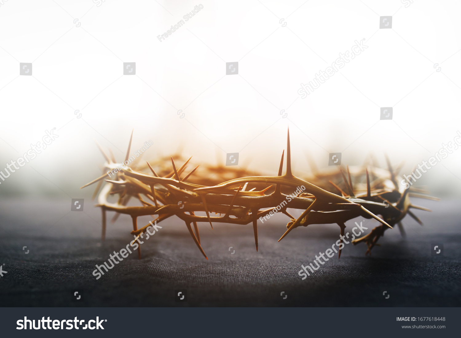 the crown of thorns of Jesus on  black background against  window light with copy space, can be used for Christian background, Easter concept #1677618448