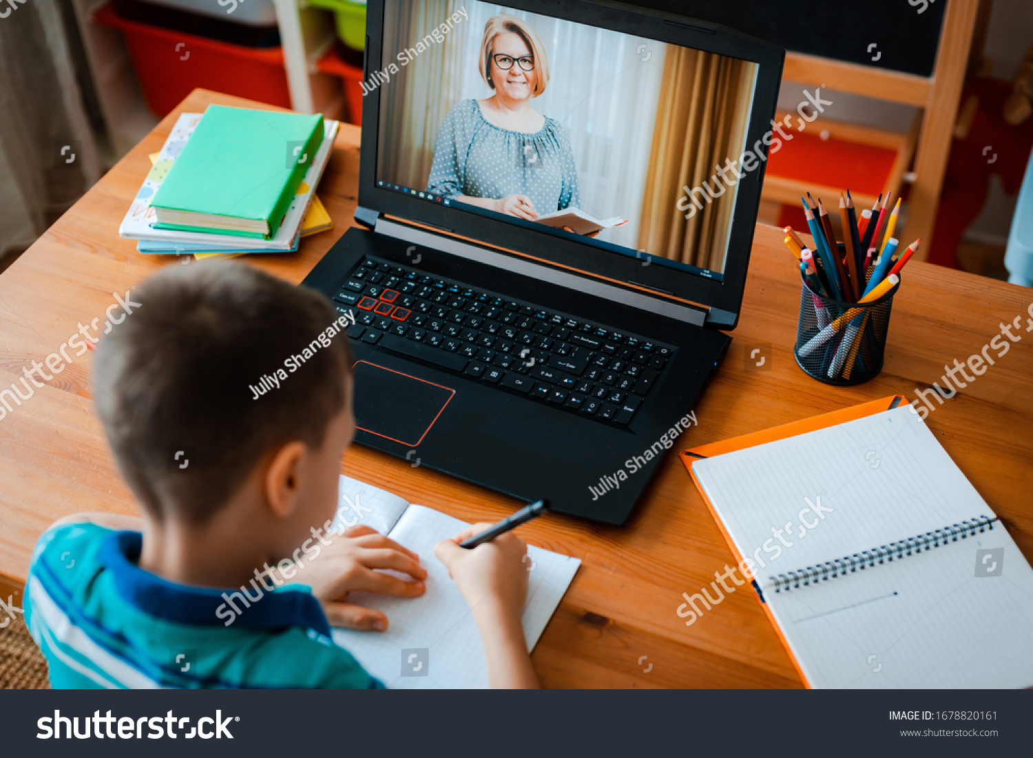 Distance learning online education. A schoolboy boy studies at home and does school homework. A home distance learning. #1678820161