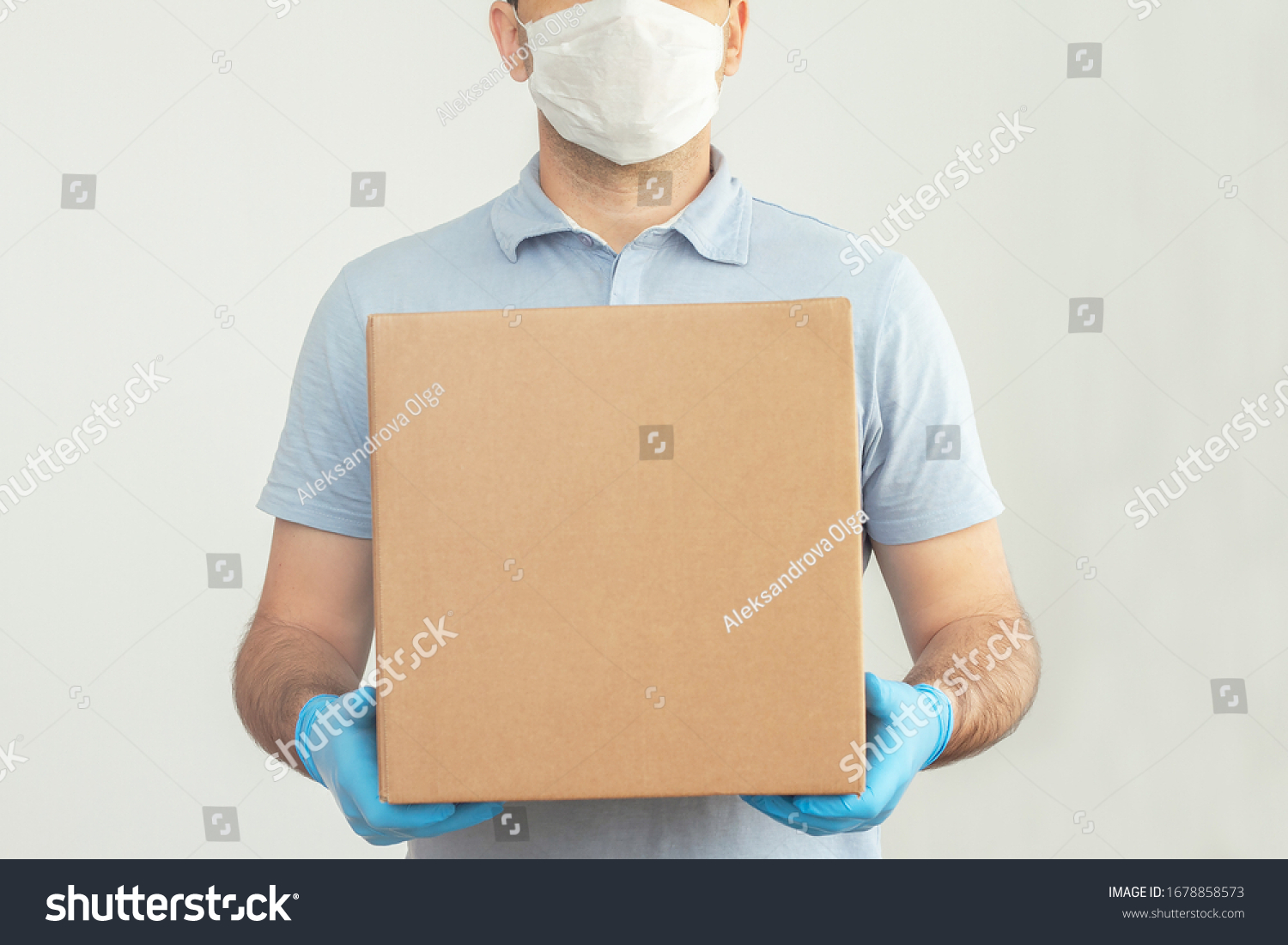 Delivery man holding cardboard boxes in medical rubber gloves and mask. copy space. Fast and free Delivery transport . Online shopping and Express delivery . Quarantine  #1678858573