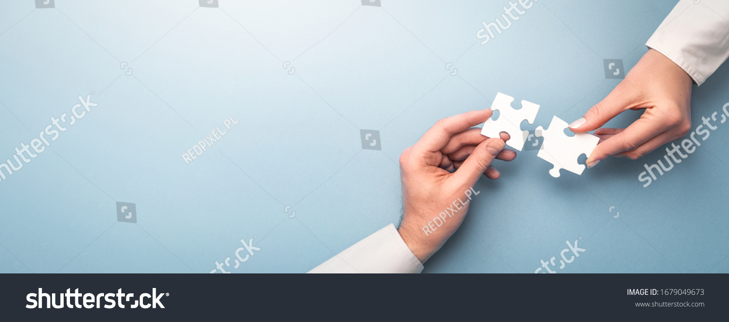 The man and woman holds in hand a jigsaw puzzle. Business solutions, success and strategy concept. #1679049673