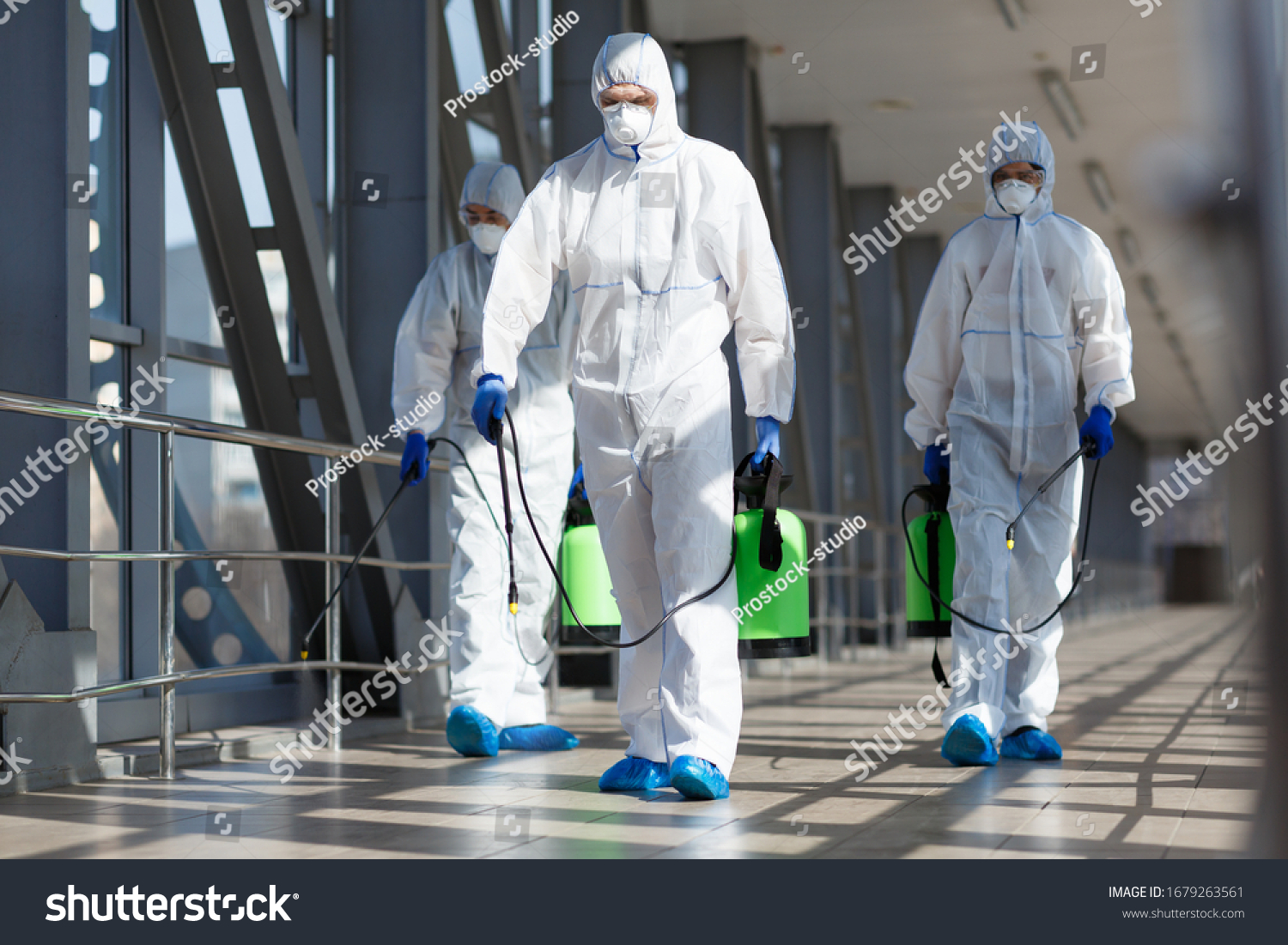 People in virus protective suits and mask disinfecting buildings of coronavirus with the sprayer, #1679263561