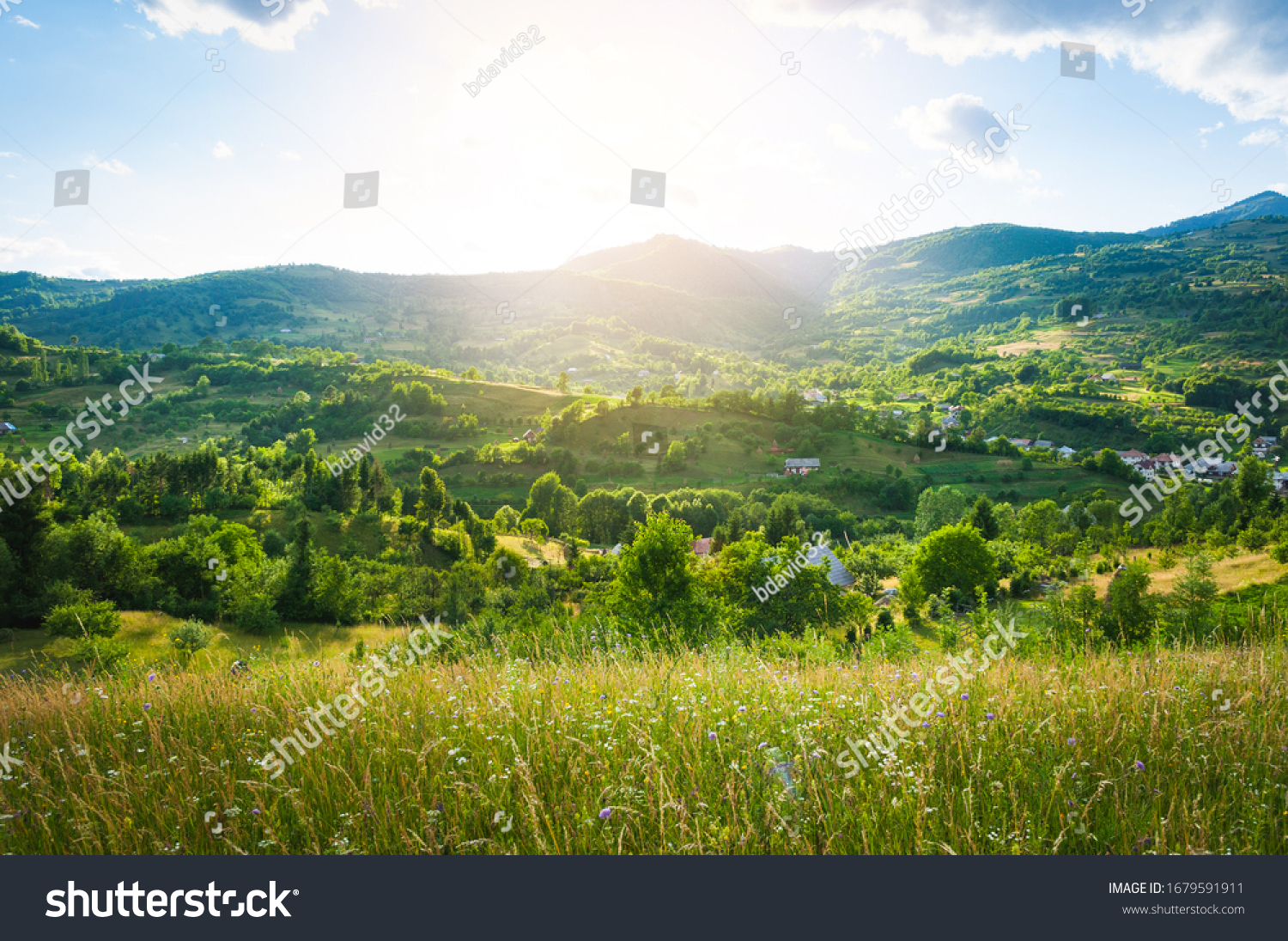 A peaceful landscape, green hills in spring time. A country road is cutting through the immaculate grass, illustrating the idea of travel , tourism or exploring #1679591911