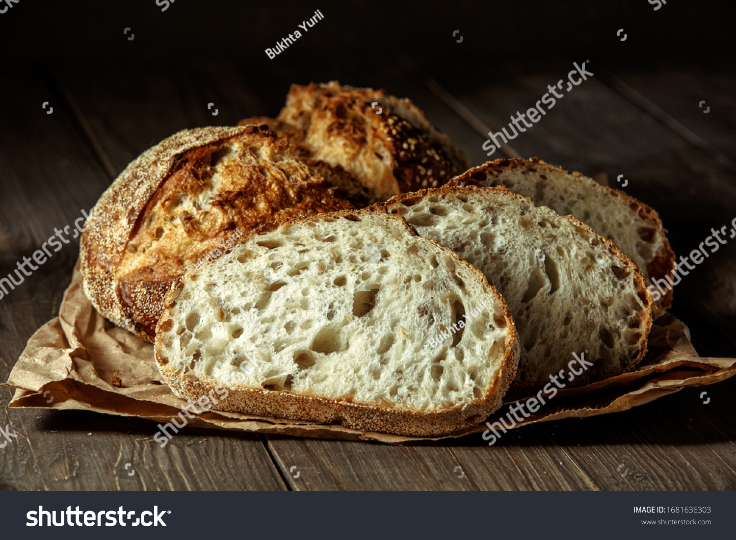 Bread, traditional sourdough bread cut into slices on a rustic wooden background. Concept of traditional leavened bread baking methods. Healthy food. #1681636303