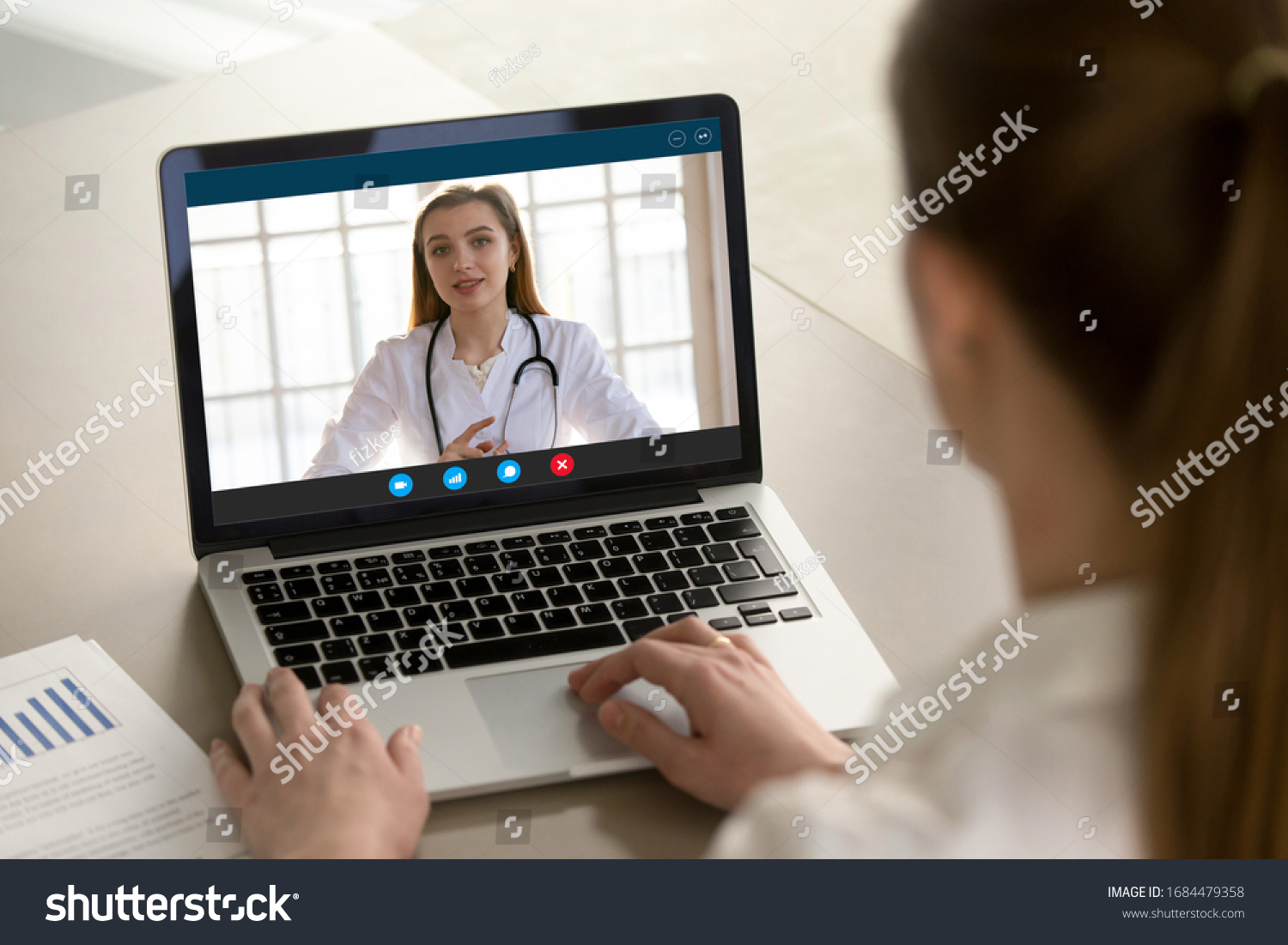 Shoulder view young woman consulting with family therapist doctor general practitioner online via video call on laptop after feeling first virus illness symptoms, medical insurance, covid19 outspread. #1684479358