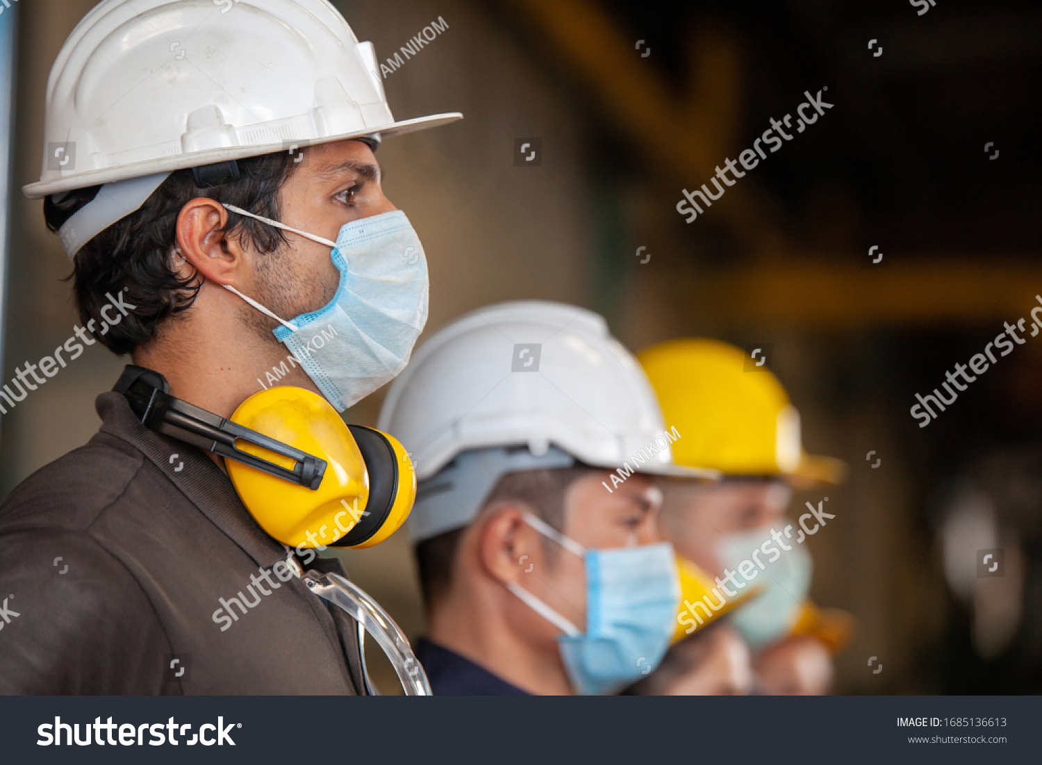 Workers wear protective face masks for safety in machine industrial factory. #1685136613