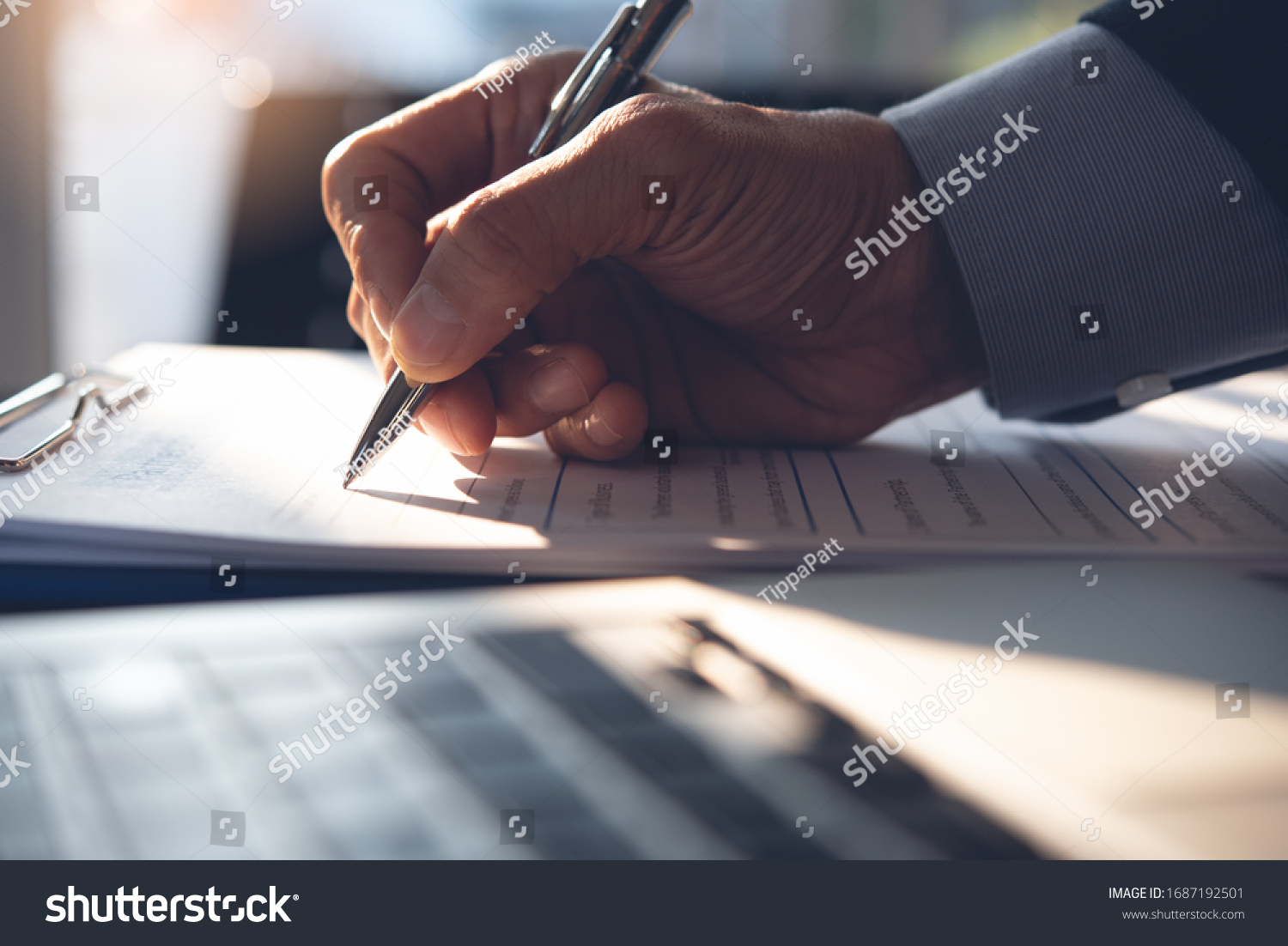 Businessman, executive manager hand filling paper business document, signing contract, partnership agreement and working on laptop computer on desk in modern office, close up #1687192501