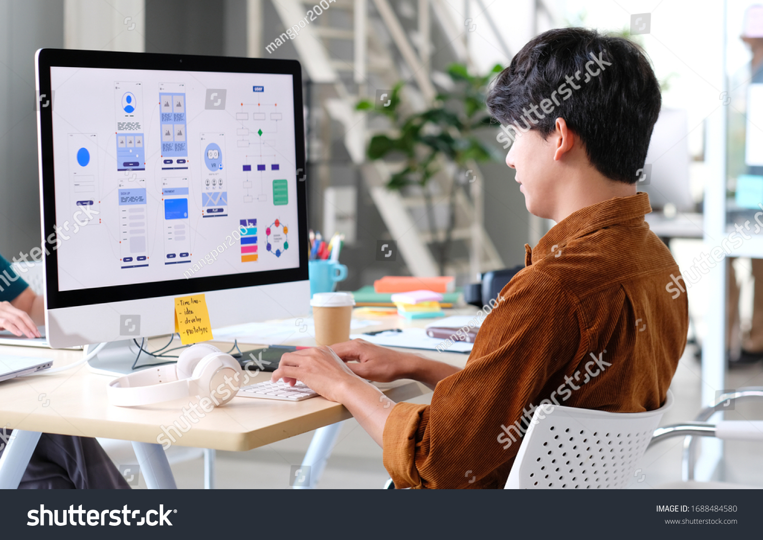 Website designer, Creative planning phone app development template layout framework wireframe design, User experience concept, Young asian man UX designer working on smartphone application at office #1688484580