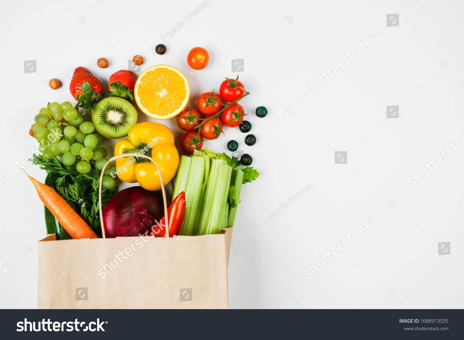 Fruits and vegetables on a light background in a Kraft bag from the store. Healthy and healthy food from the farmers ' market. Space for text #1688913535