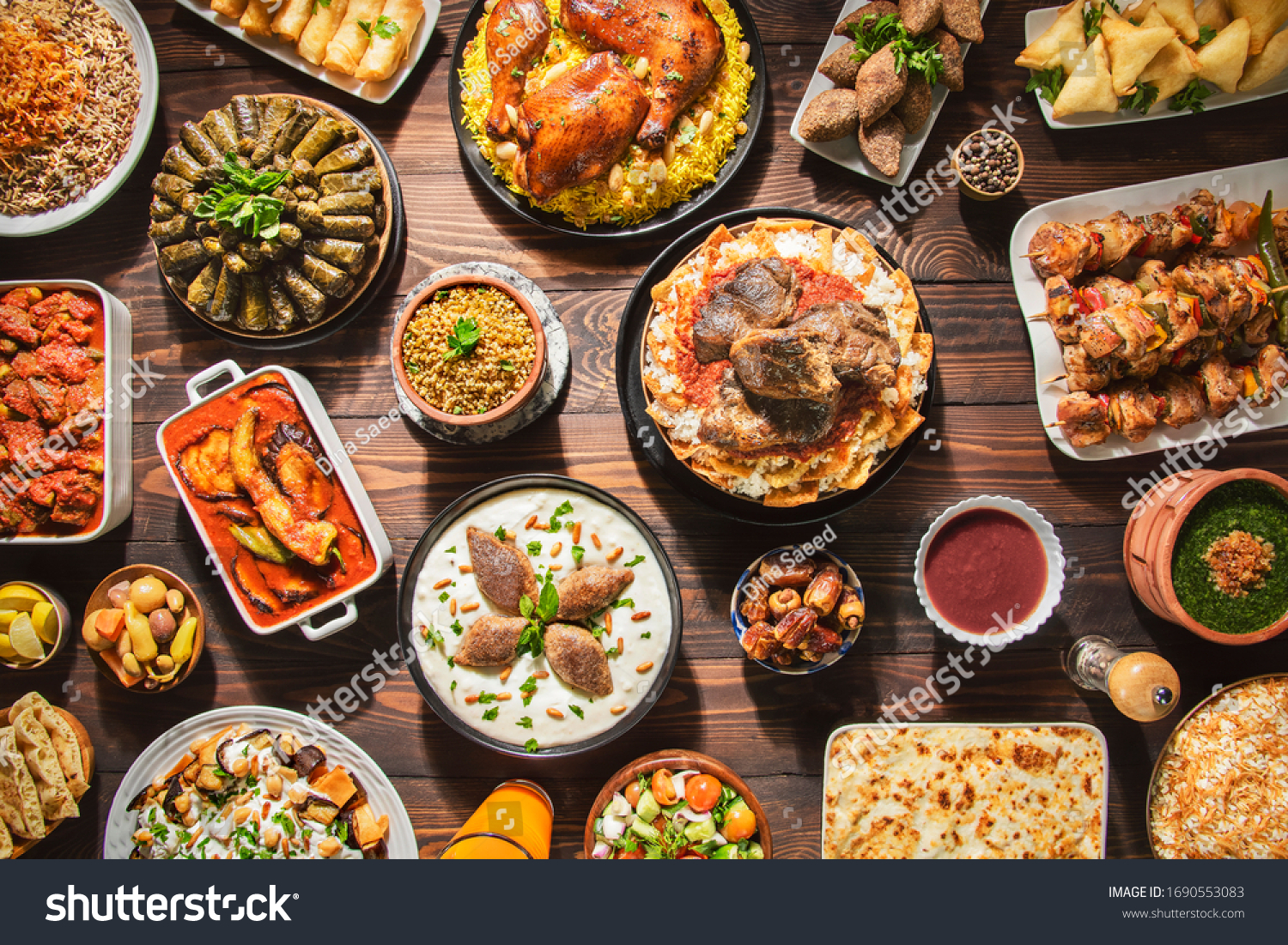 Arabic Cuisine: Middle Eastern traditional lunch. It's also Ramadan "Iftar". The meal eaten by Muslims after sunset during Ramadan. Assorted of Arabic oriental dishes. top view with close up.  #1690553083