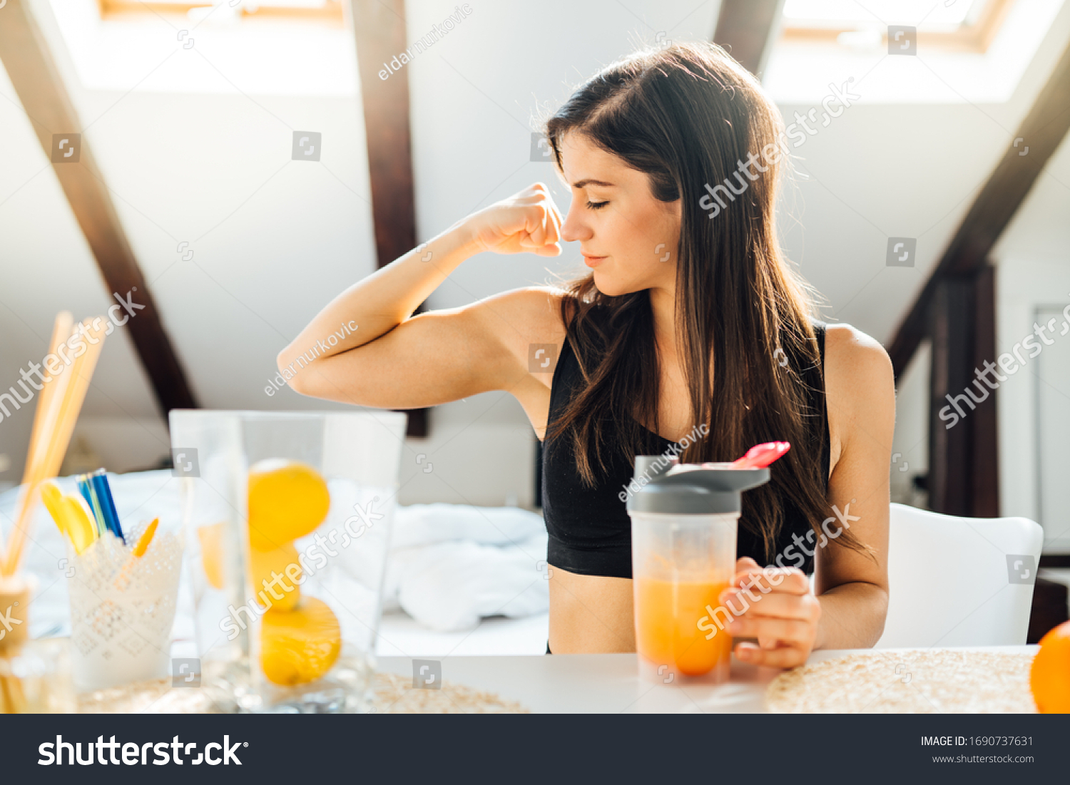 Woman at home drinking orange flavored amino acid vitamin powder.Keto supplement.After exercise liquid meal.Weight loss fitness nutrition diet.Immune system support.Organic citrus fruit drink #1690737631