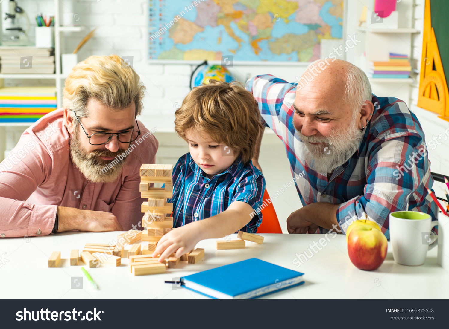 Family tree. Pupil with father and grandfather enjoying together at home. Excited teach. Three different generations ages: grandfather father and child son together #1695875548