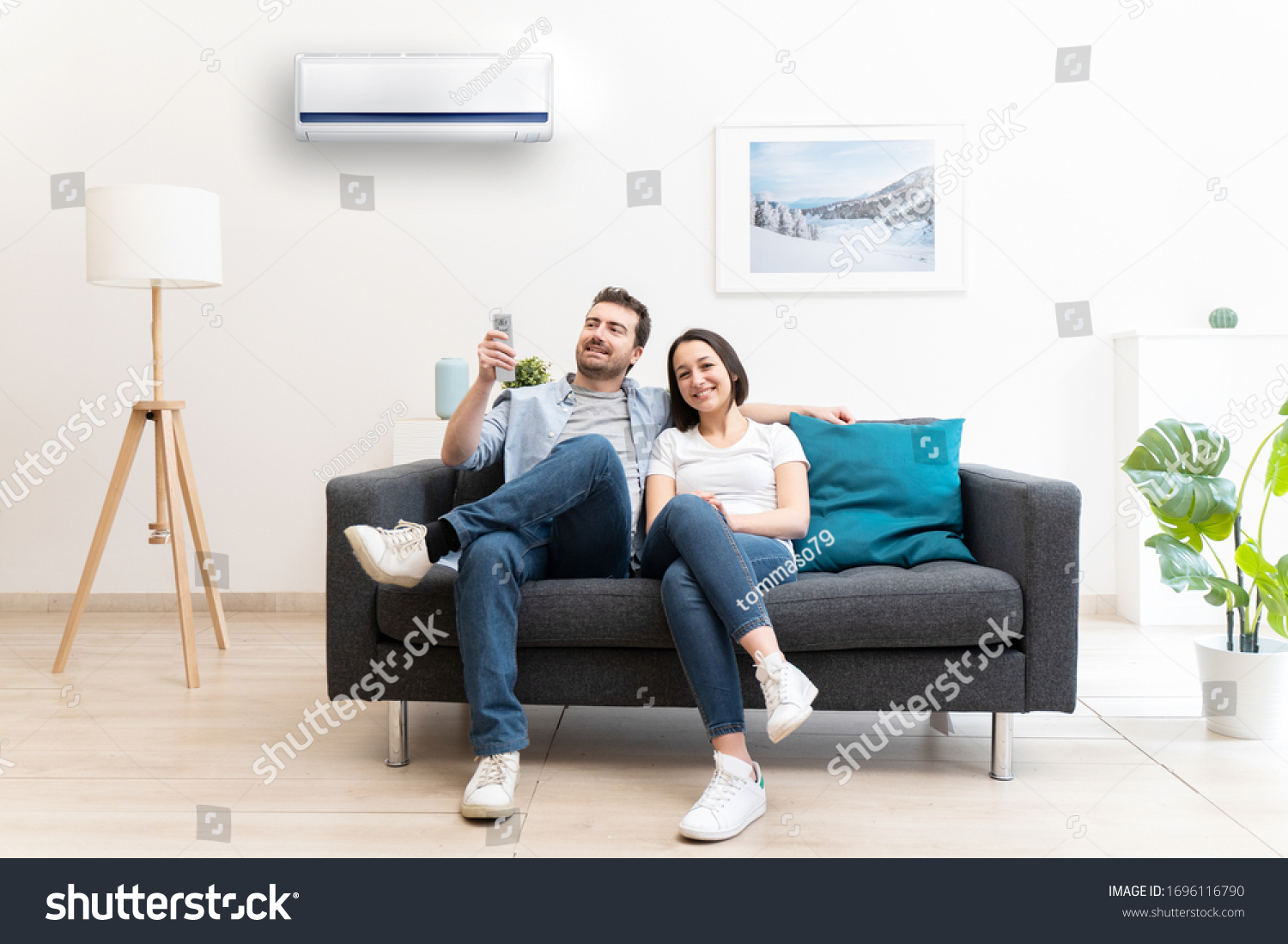 Happy couple freshen up using air conditioner at home #1696116790