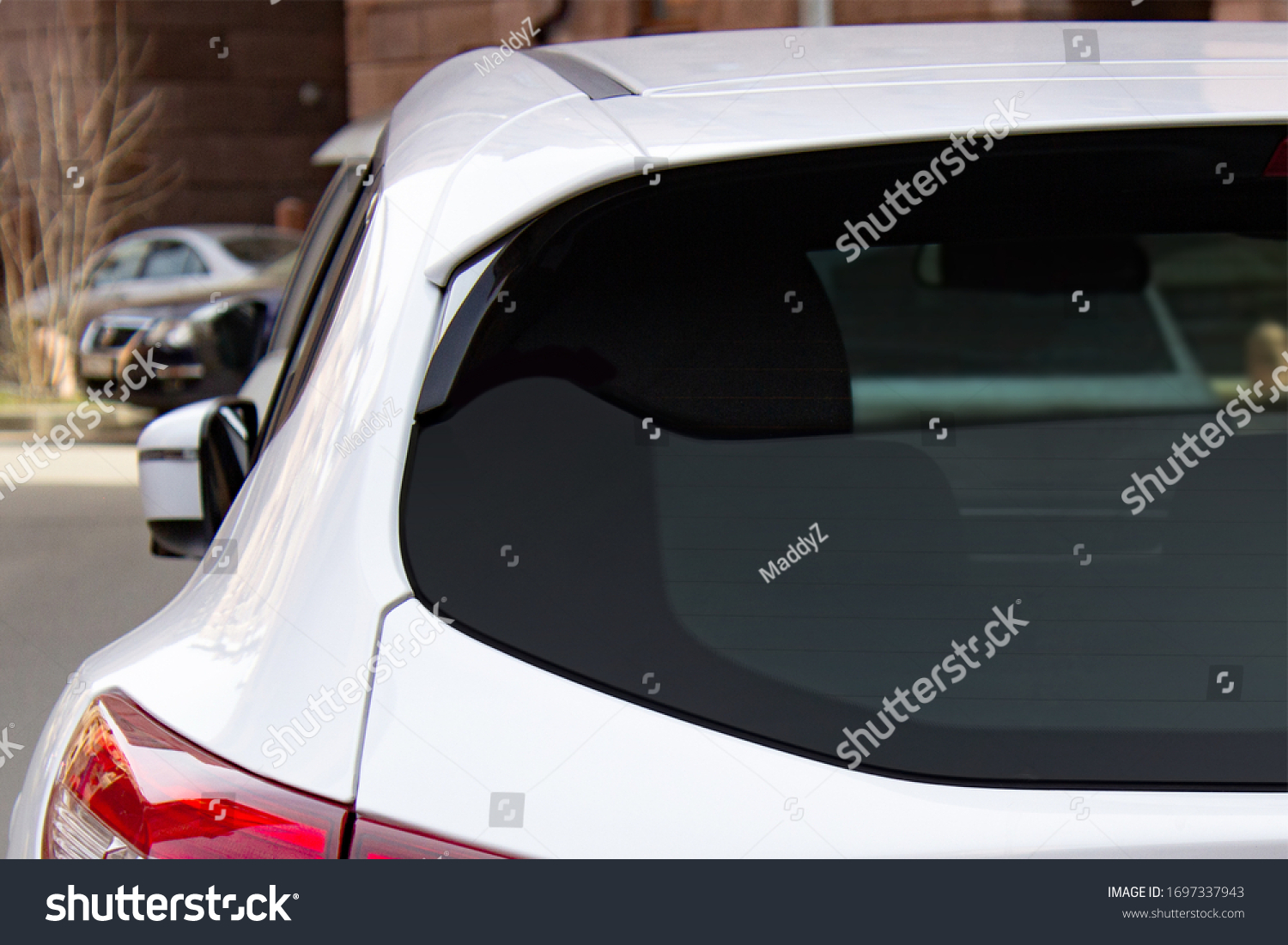 Back window of a white car parked on the street, rear view. Mock-up for sticker or decals #1697337943