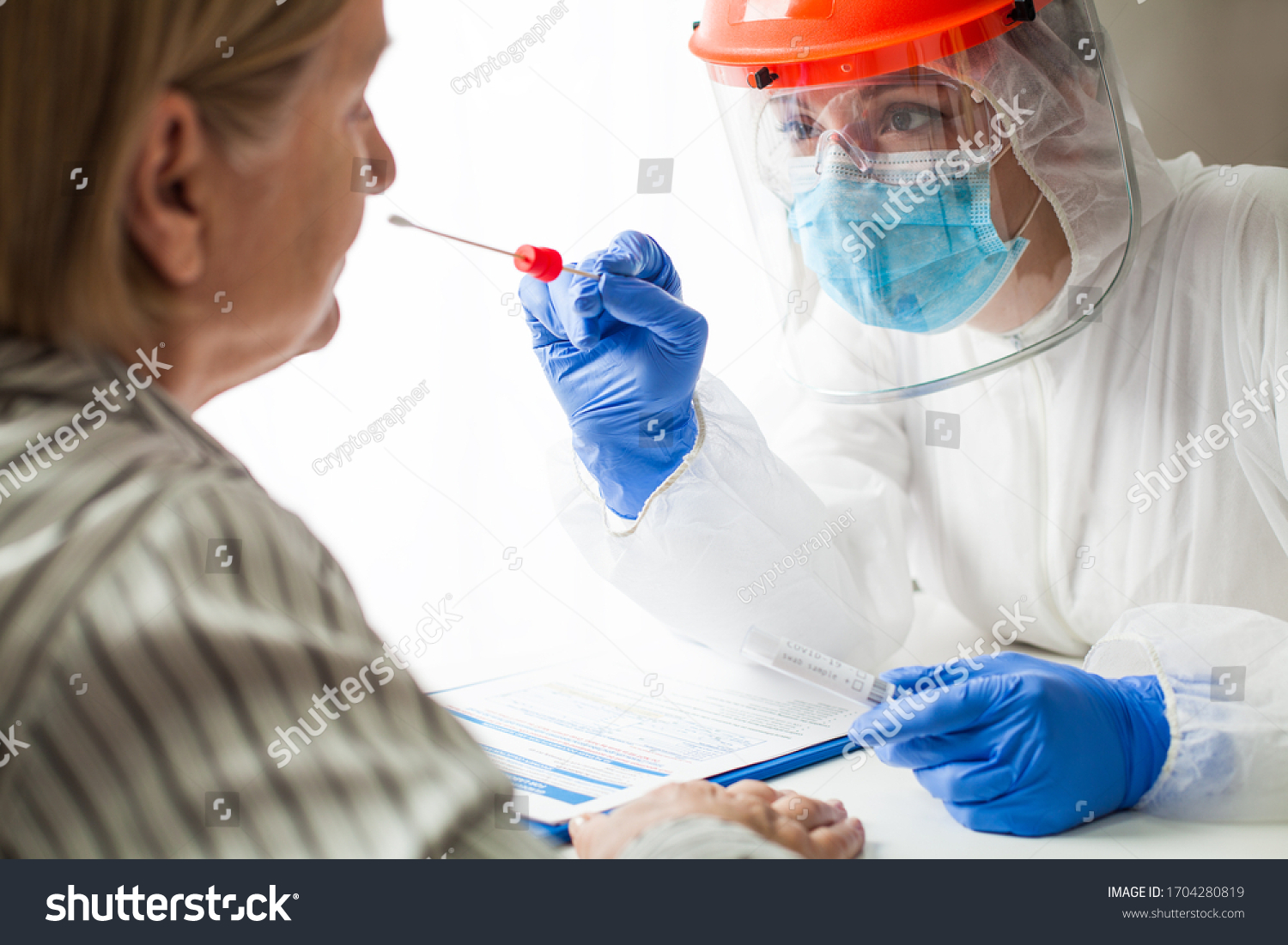 Physician wearing personal protective equipment performing a Coronavirus COVID-19 PCR test, patient nasal NP and oral OP swab sample specimen collection process, viral rt-PCR DNA diagnostic procedure #1704280819