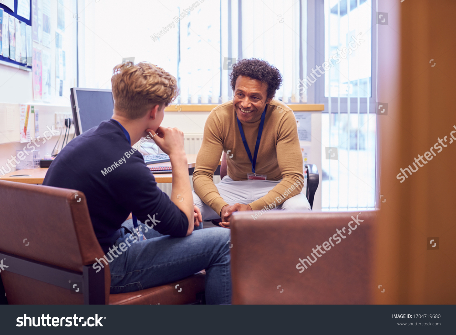 Male College Student Meeting With Campus Counselor Discussing Mental Health Issues #1704719680