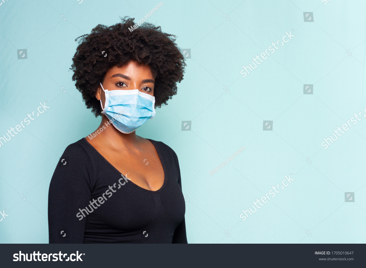 young black model wearing protective mask and black shirt and black power hair #1705010647