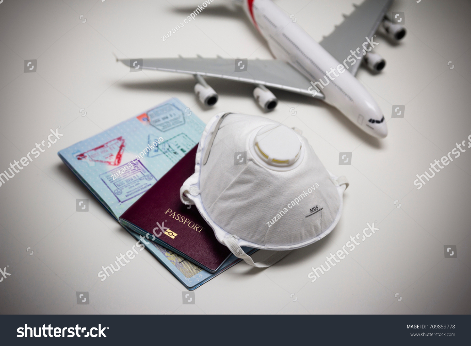 Travelling during corona virus epidemic. Passport and protective face mask respirator. Coronavirus and travel concept. Travelling with face mask. Corona virus prevention. Flights cancelled. Stay Home. #1709859778