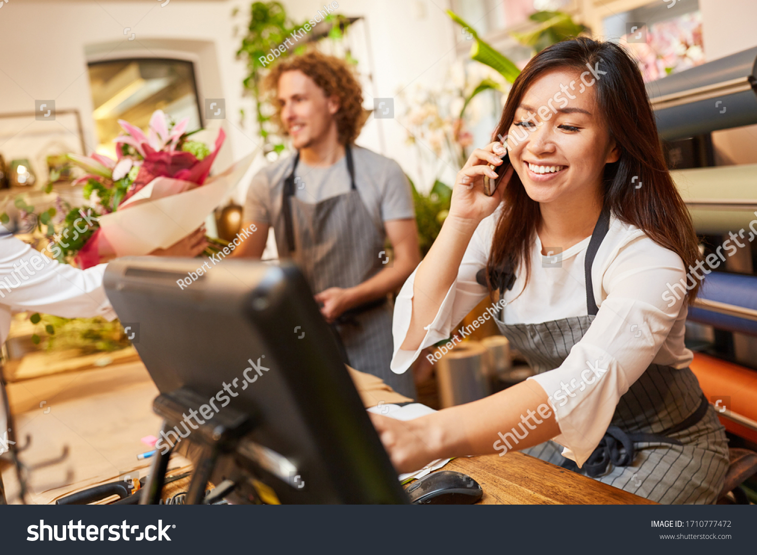 Saleswoman or florist takes order on the phone #1710777472