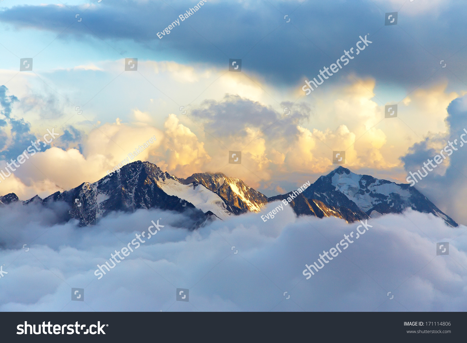 alpine landscape with peaks covered by snow and clouds #171114806