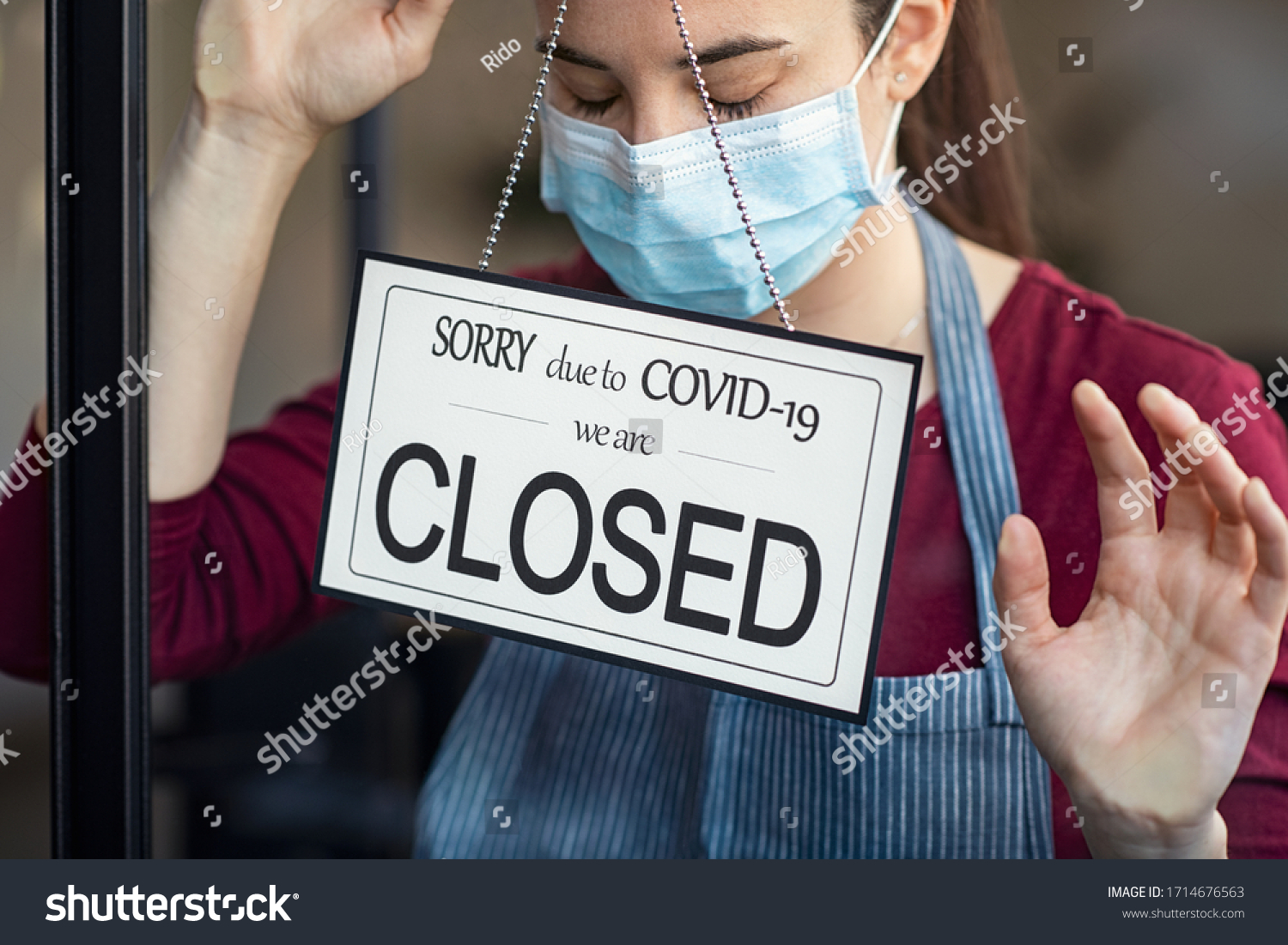 Stressed owner forced to close the restaurant permanently due to restrictions on the coronavirus. Depressed businesswoman closing her business activity due to covid-19. Small business bankrupt. #1714676563