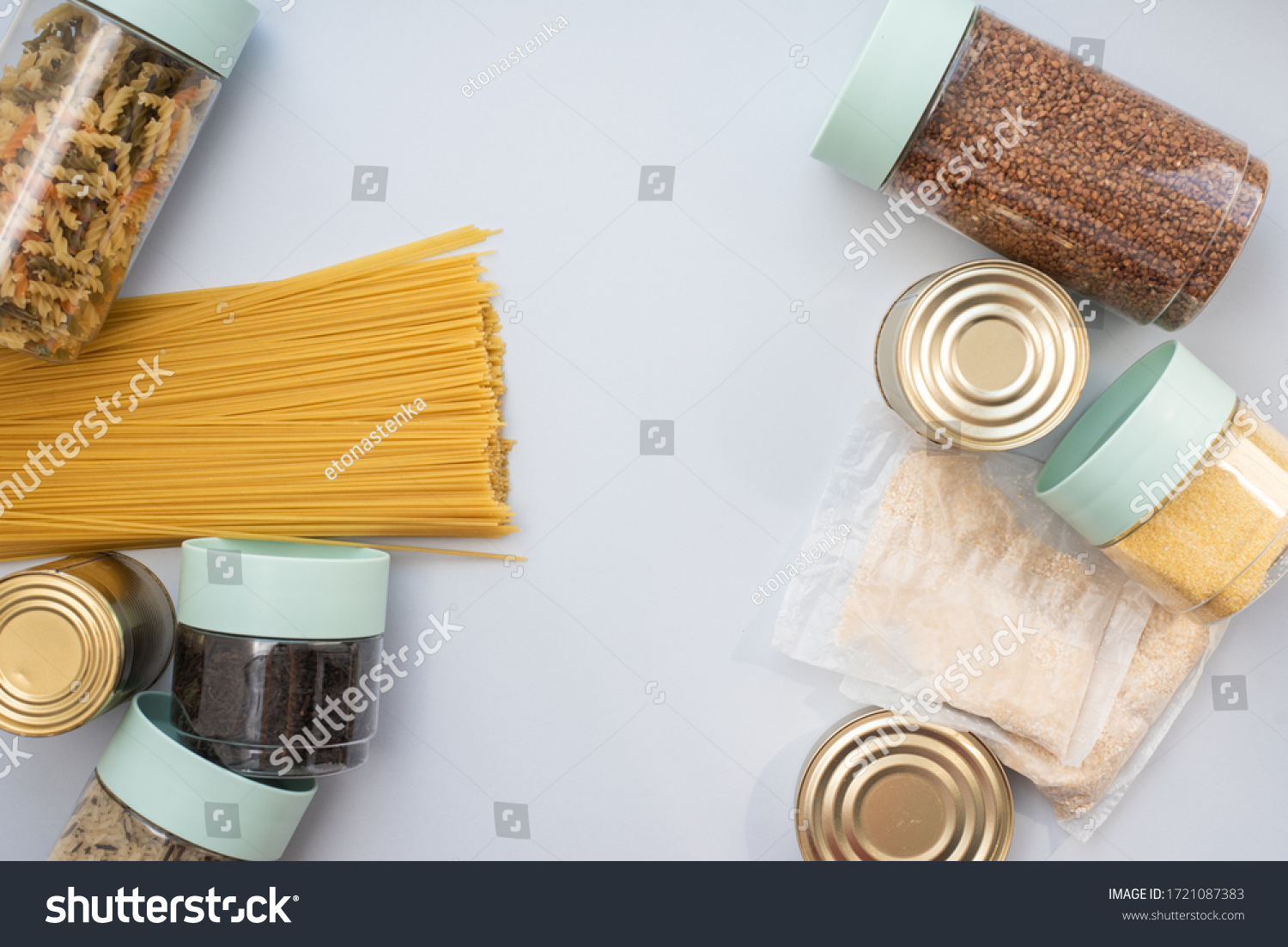 Canned food, pasta, groats and pasta on a blue background. Donates for low-income families during the coronavirus #1721087383