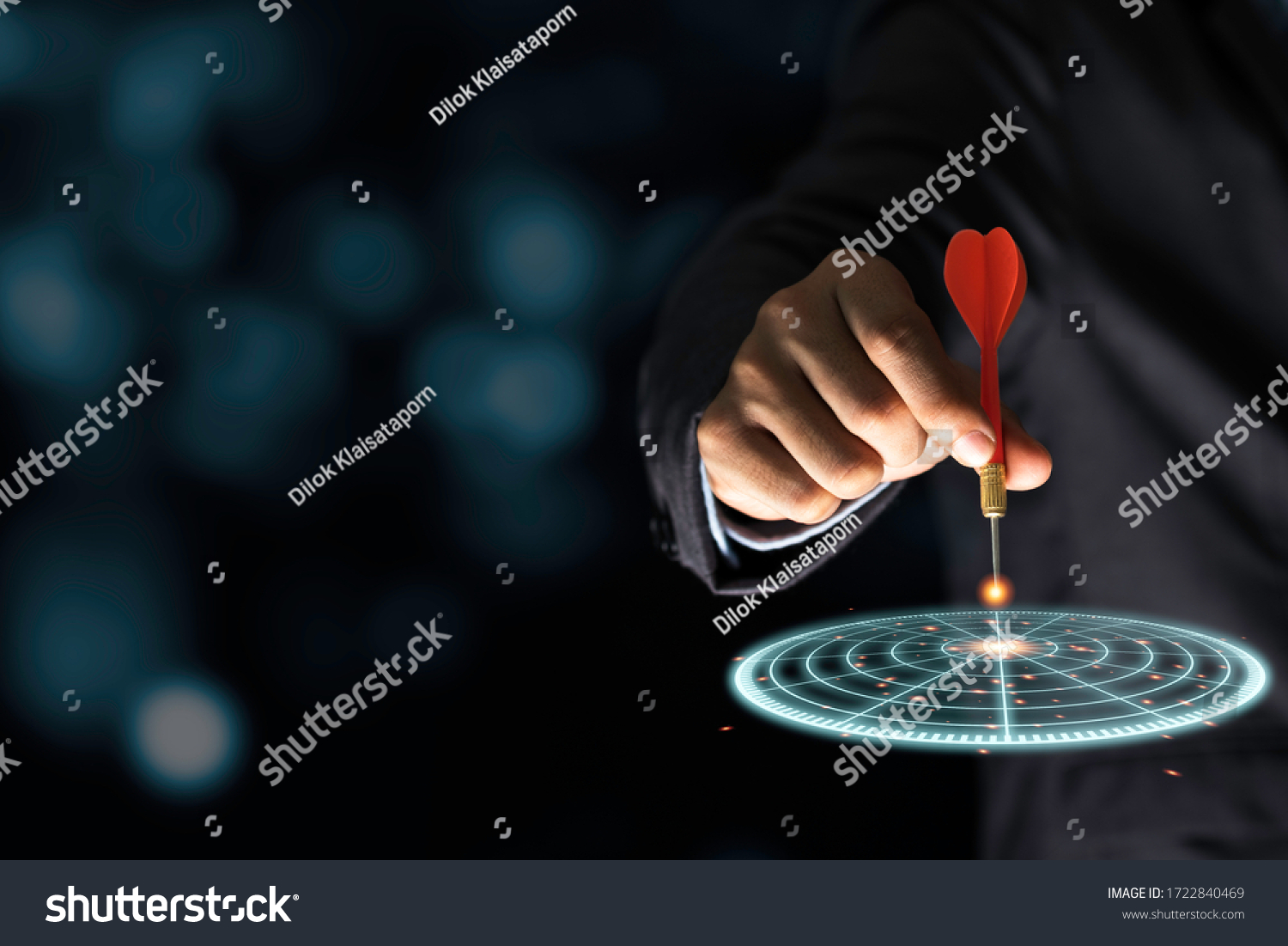 Businessman throwing red arrow dart to virtual target dart board. Setup objectives and target for business investment concept. #1722840469