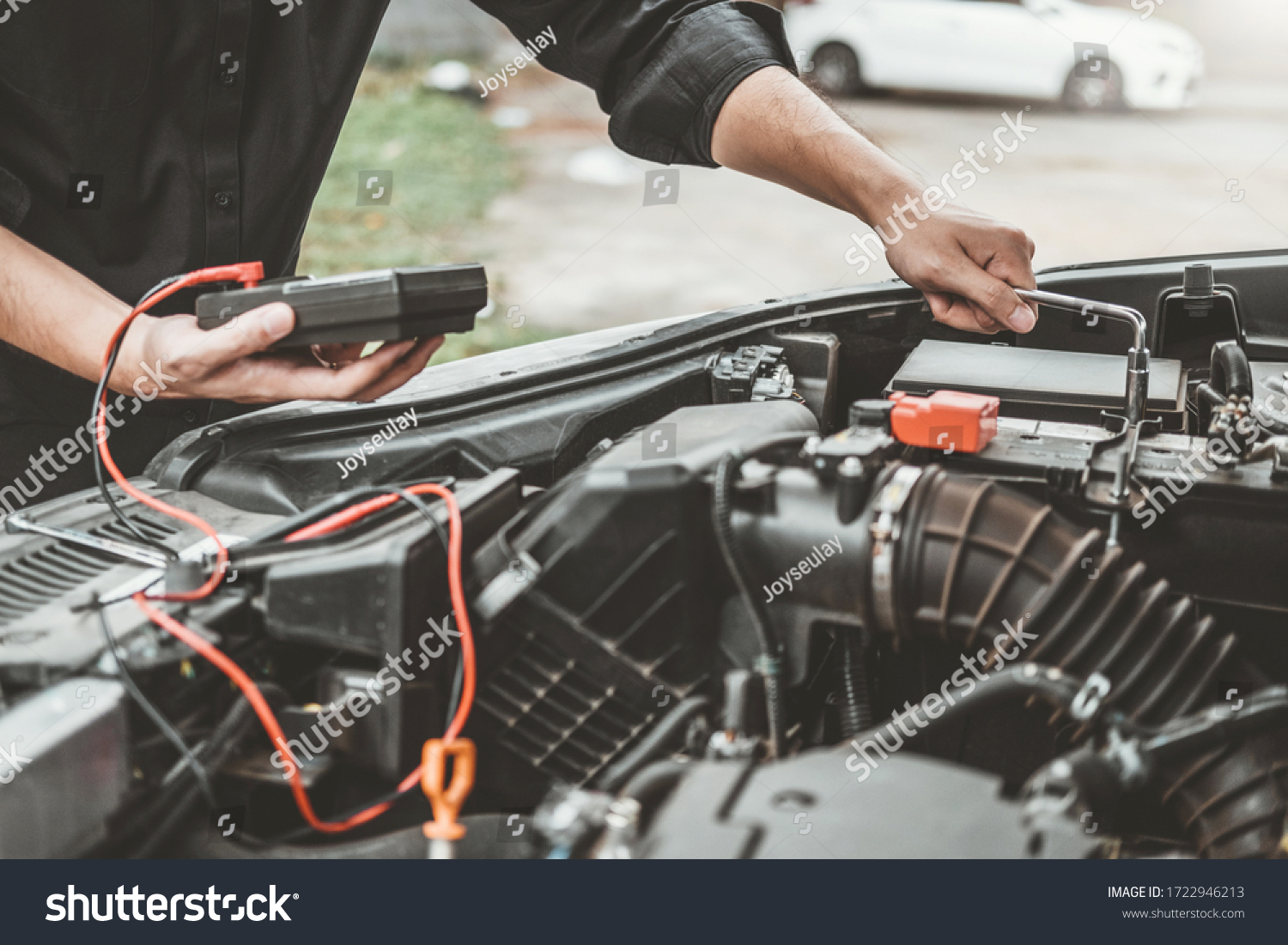 Auto mechanic working in garage Technician Hands of car mechanic working in auto repair Service and Maintenance car battery check. #1722946213