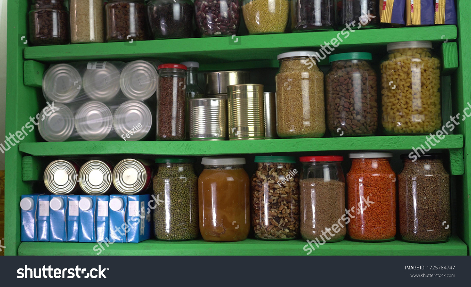 Buying food in bulk during the coronavirus lockdown period. Home pantry shelves with long-term storage and canned products #1725784747