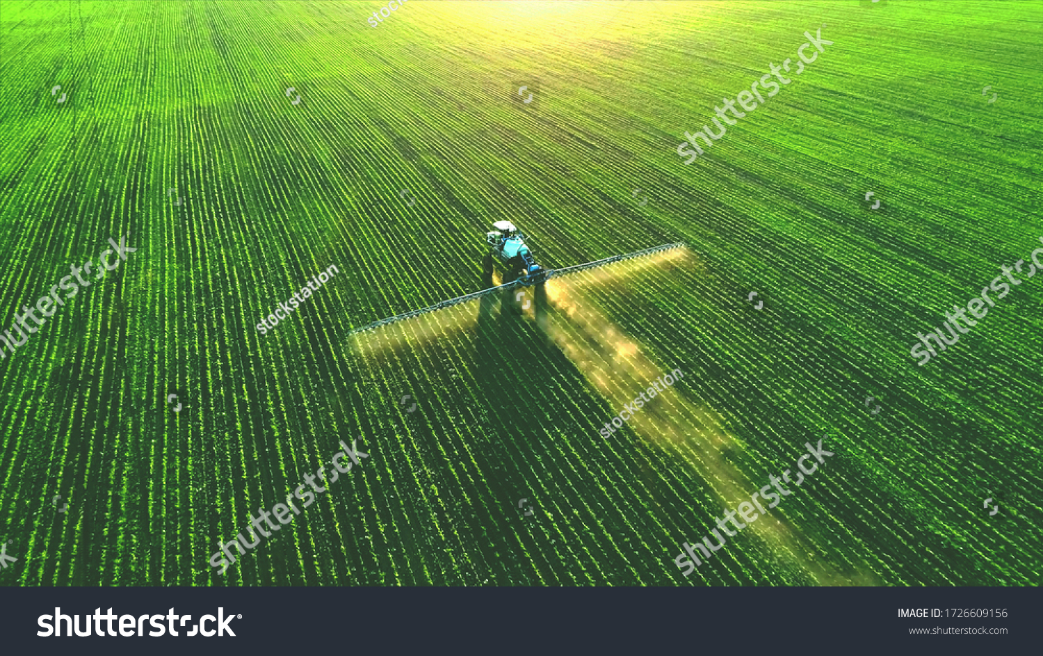 Tractor spray fertilizer on green field drone high angle view, agriculture background concept. #1726609156