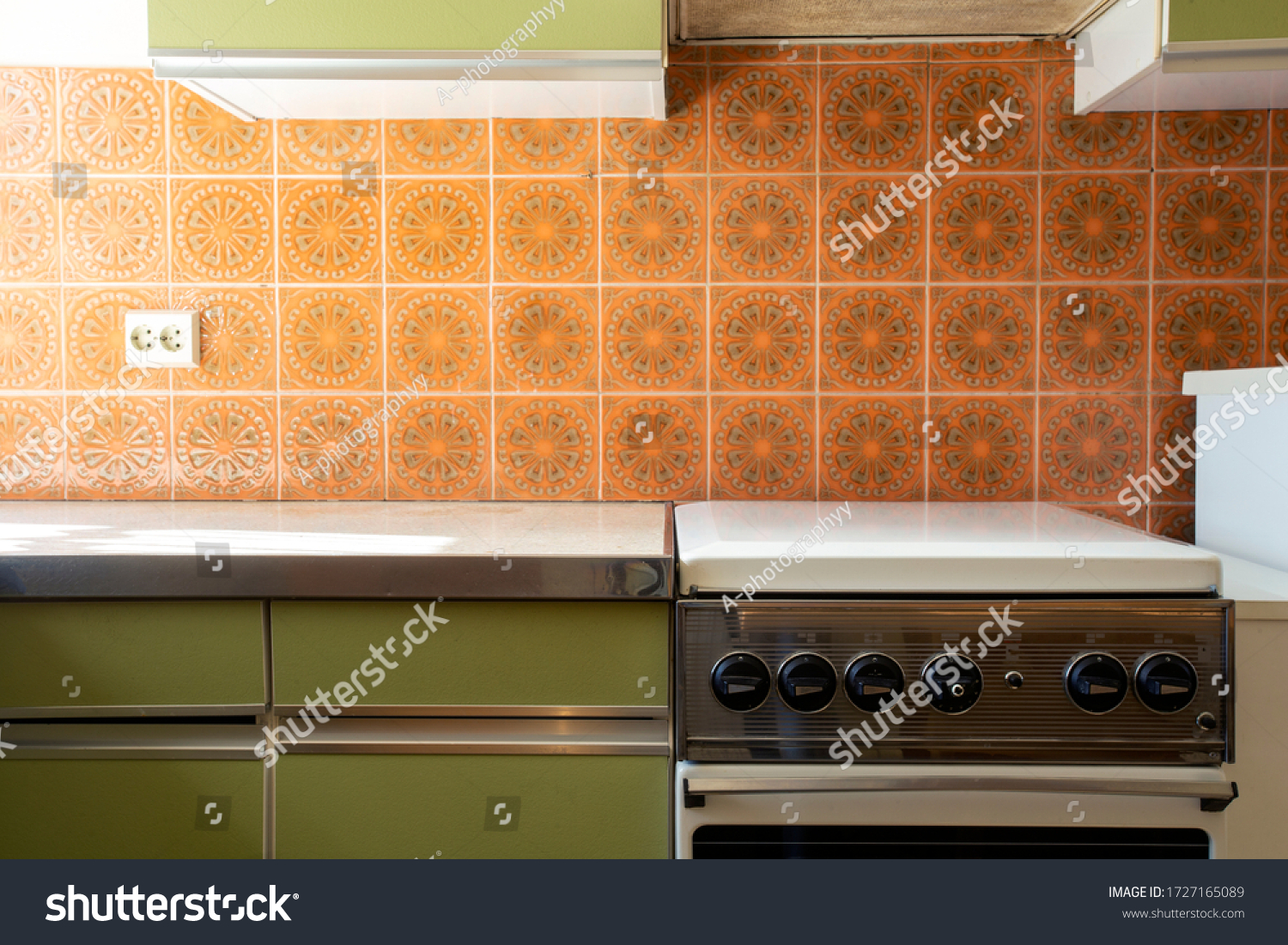 Vintage retro kitchen with orange pattern tiles, american retro kitchen home interior design 70's style close-up #1727165089