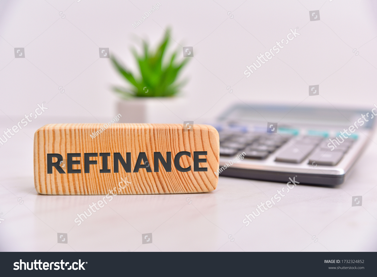 Refinance word on wooden block. Office table background. #1732324852